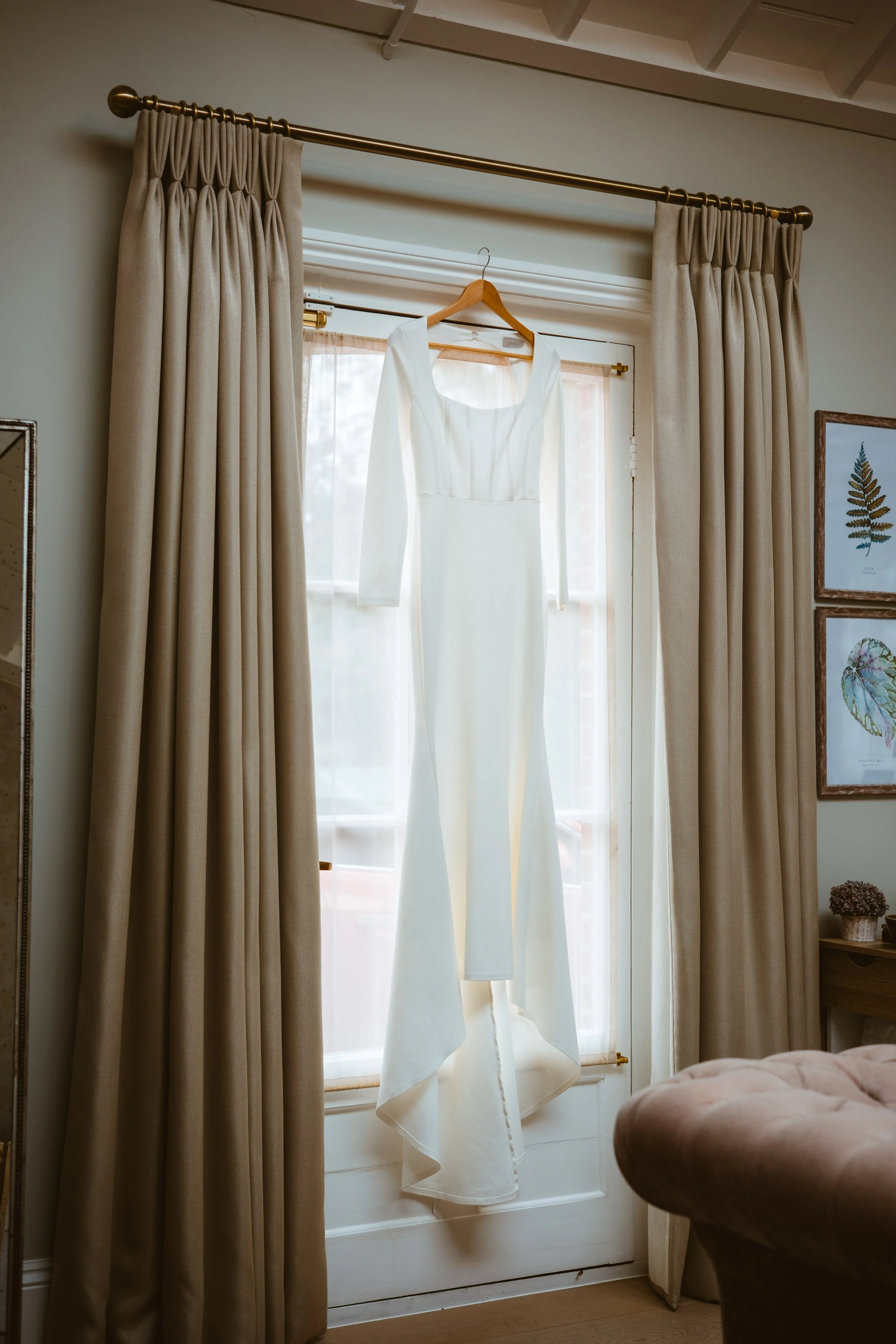 Bridal gown hanging up in the window