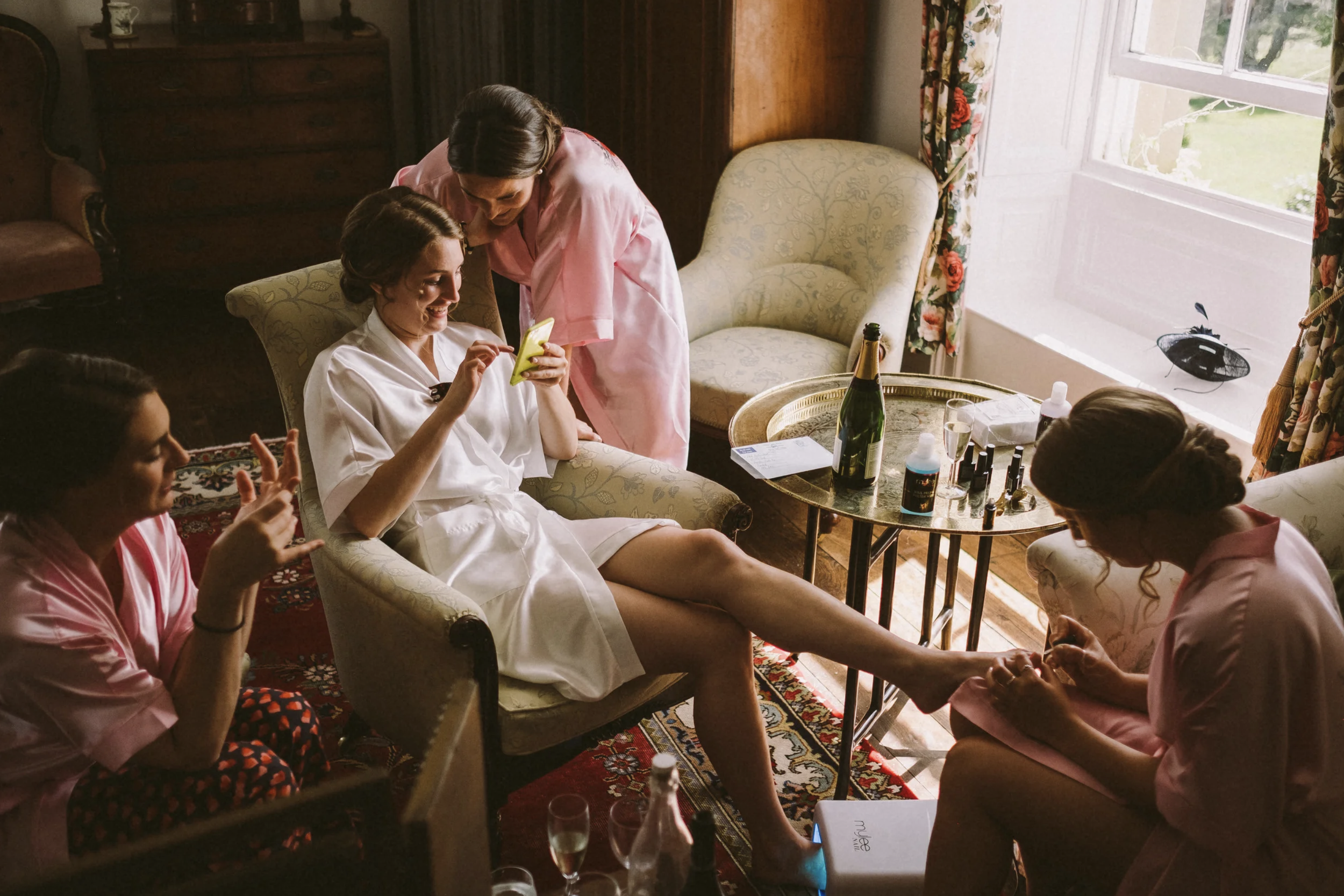 Bride getting ready with her bridesmaids on the morning of her wedding at Homme House