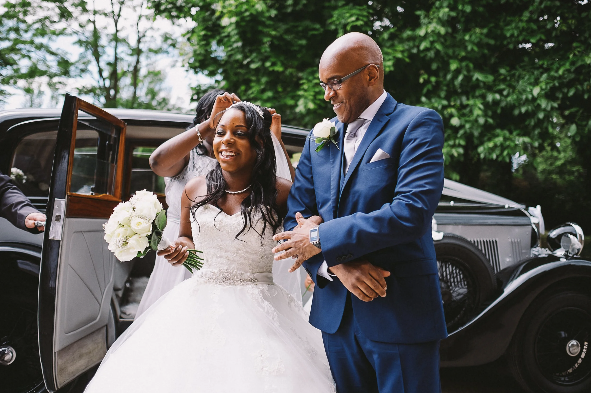 Bride and her father getting out of a car