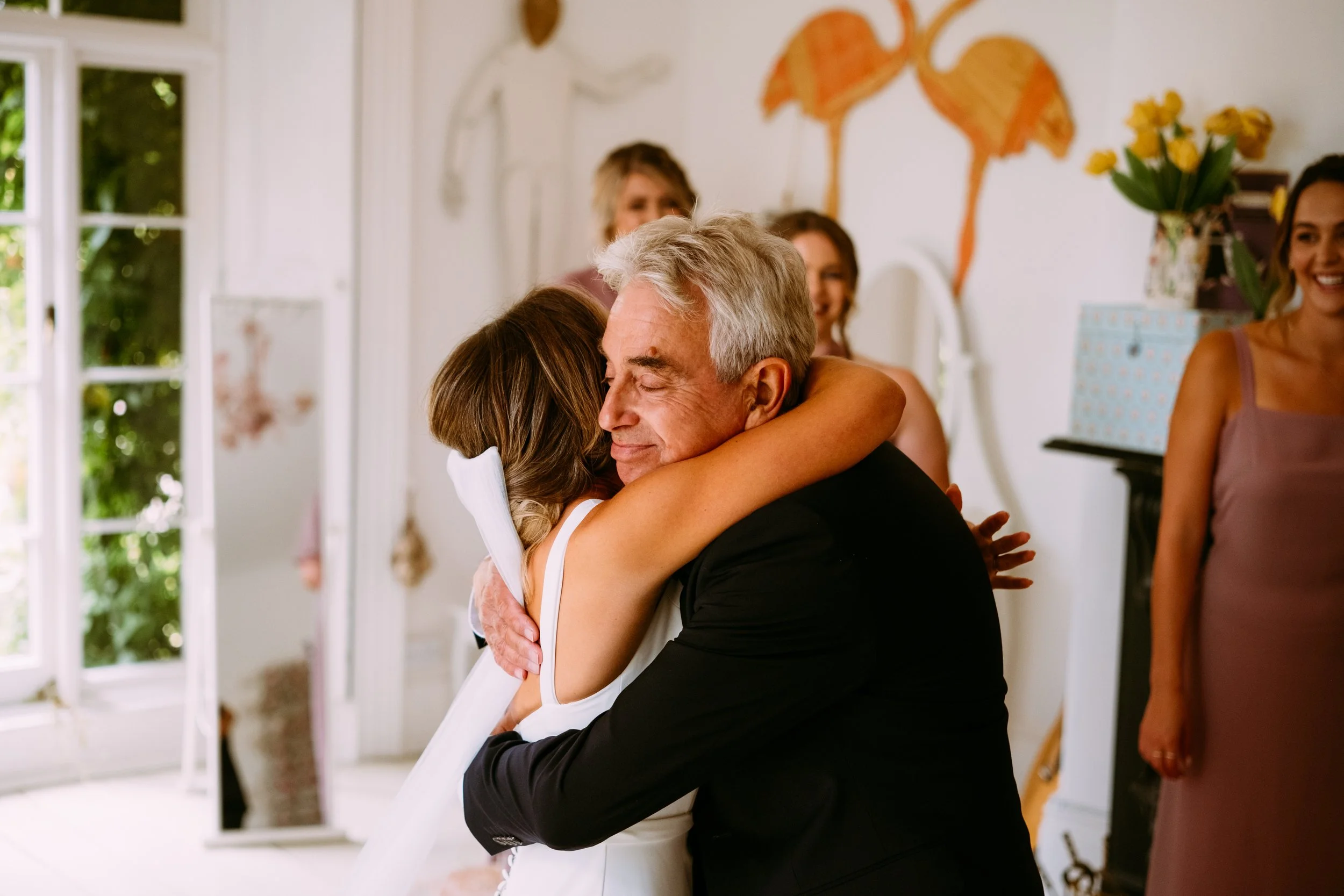 Bride hugging her dad during an emotional moment before the wedding ceremony at Lyde Court