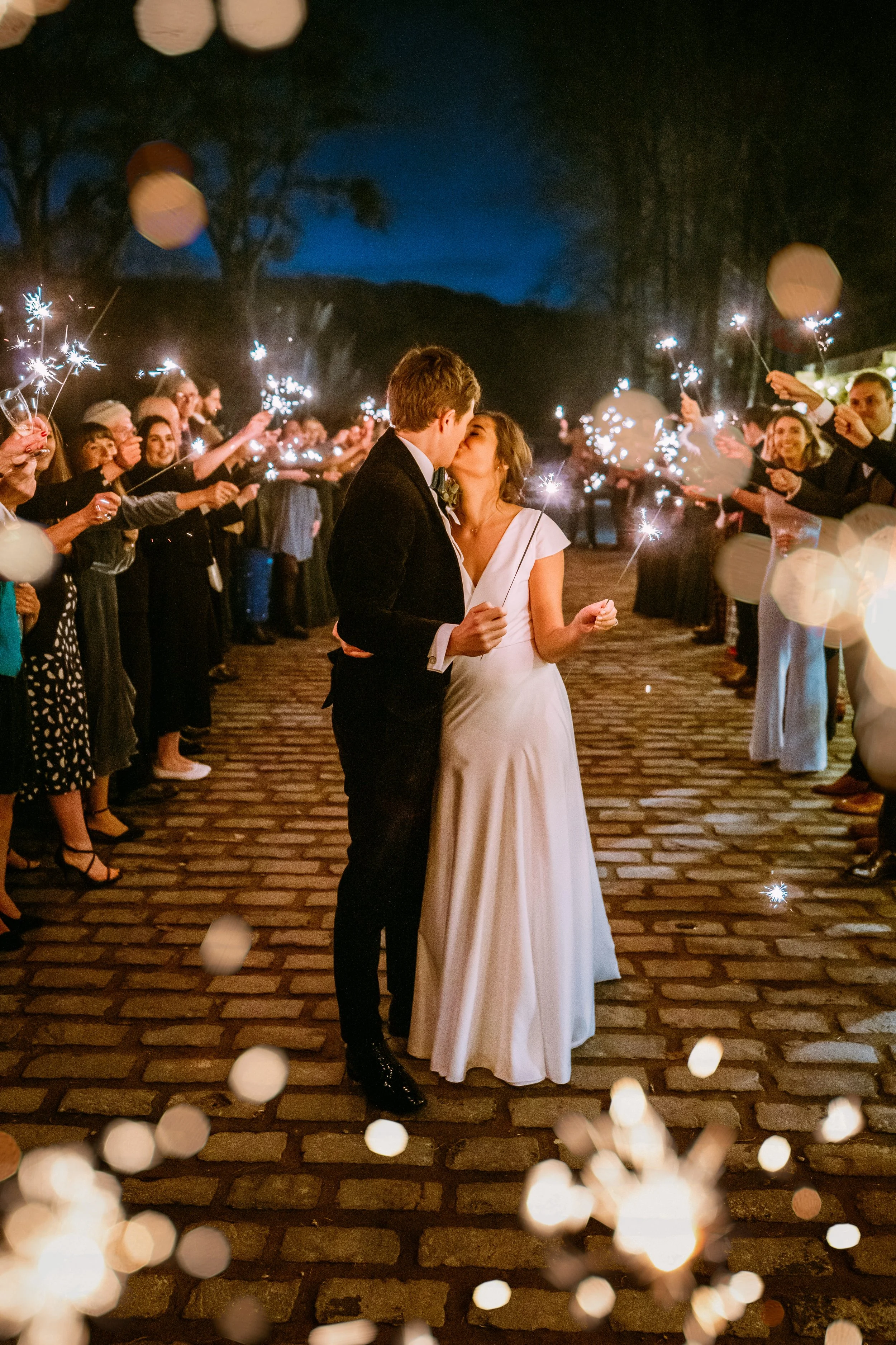 Bride and groom playing with sparklers