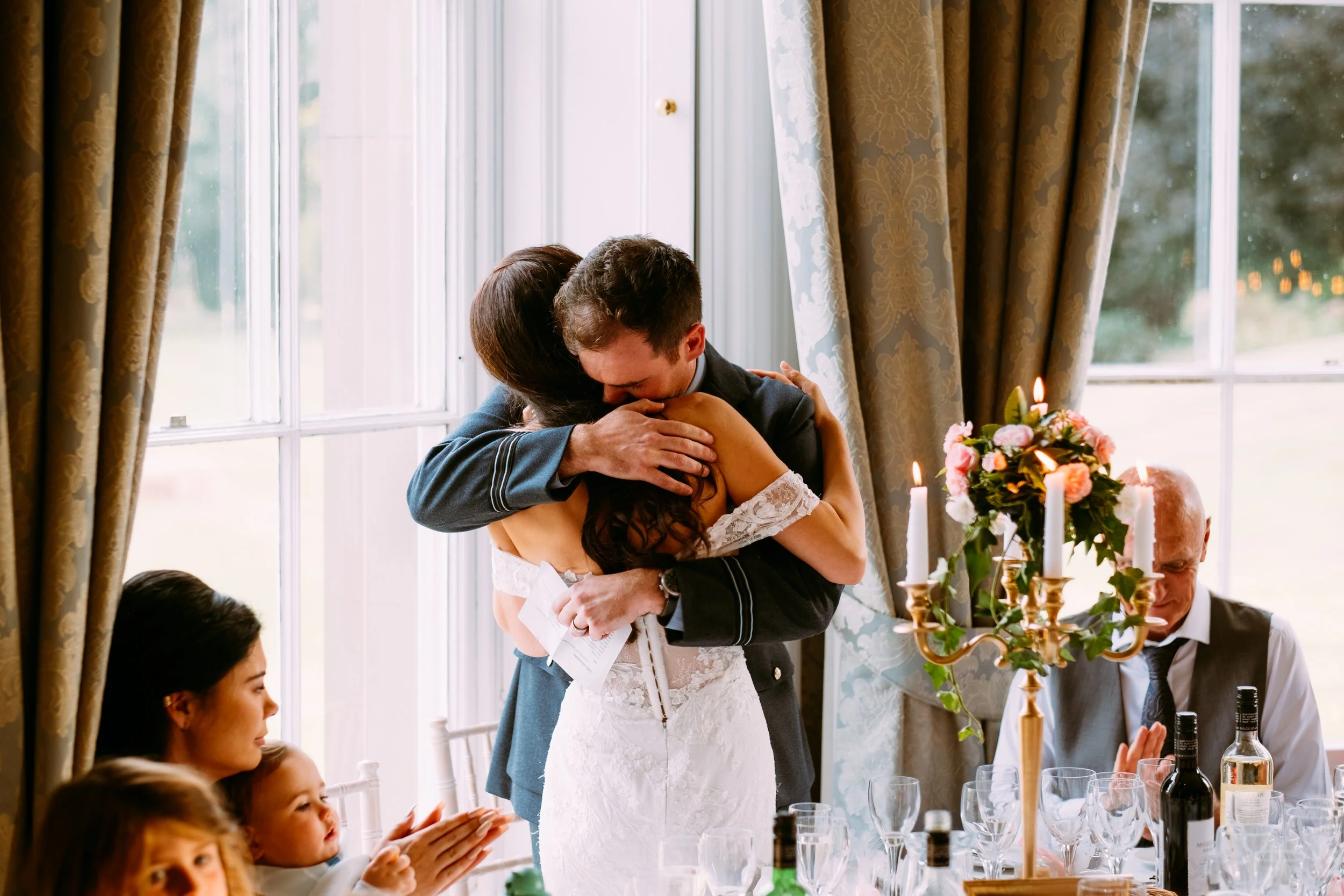Bride and groom hugging during speeches