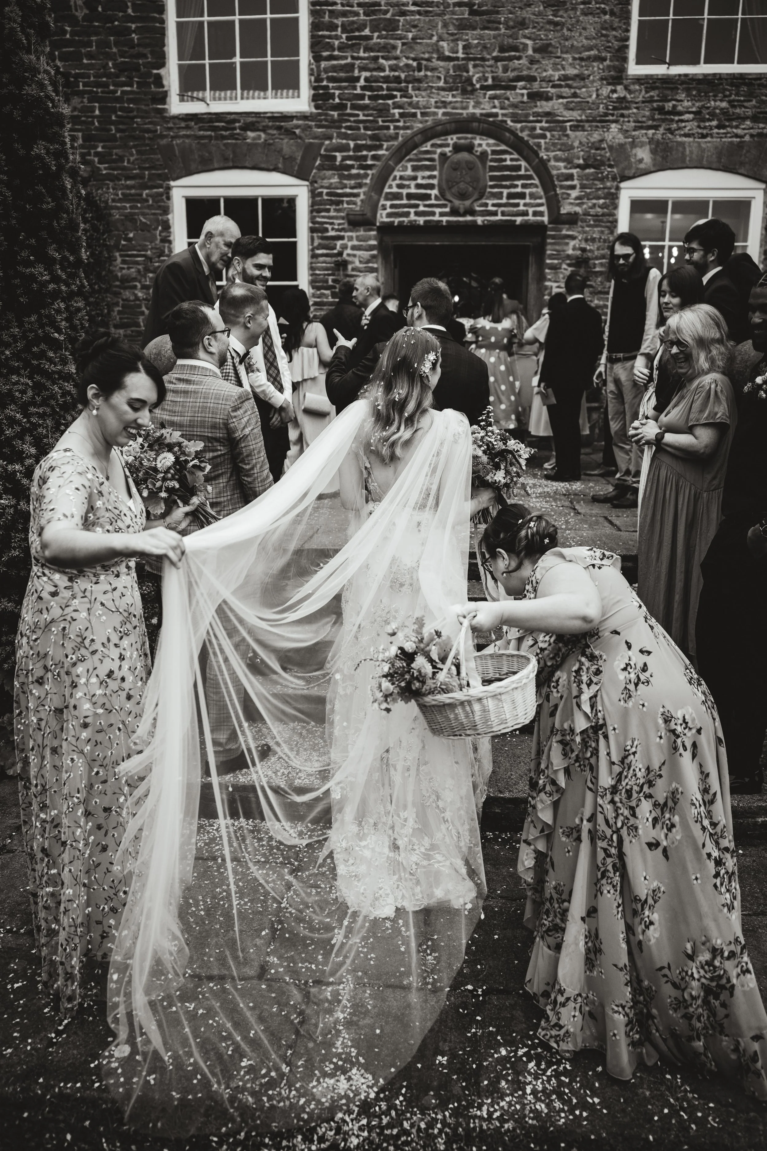 Guests helping the bride with her view at Dewsall Court