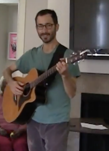 Jacobs playing guitar for assisted living residents with dementia in Berkeley
