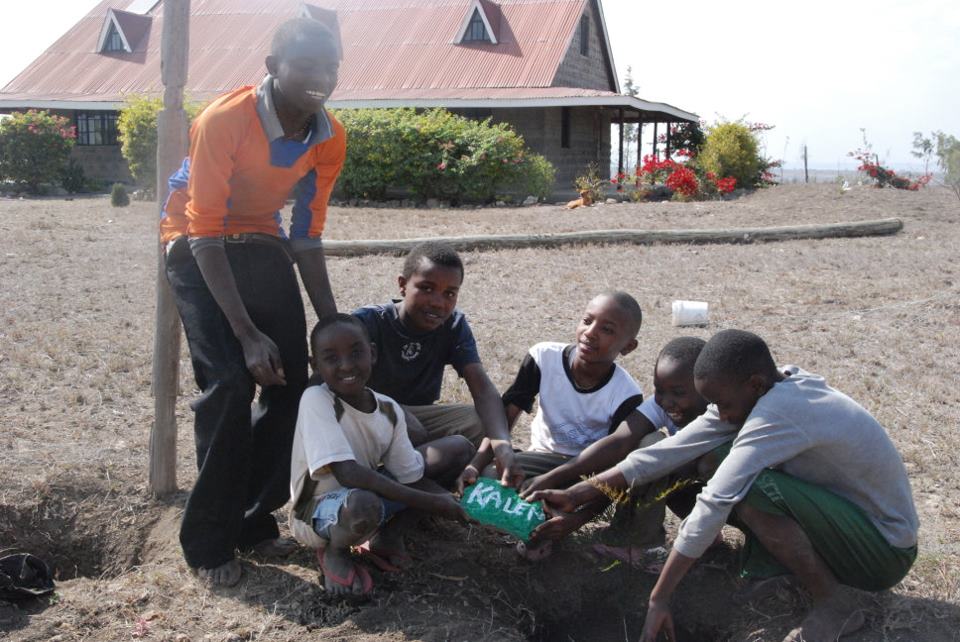  Many people have supported from afar. We painted thier names and dedicated trees in their honor. Here are the boys surrounding one of the rocks 