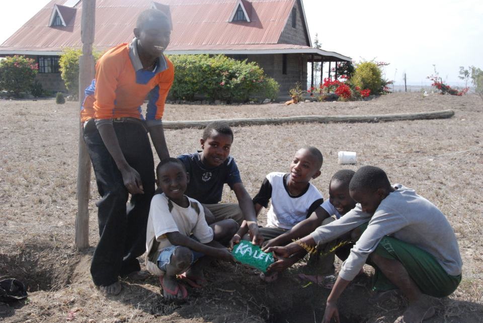 Many people have supported from afar. We painted thier names and dedicated trees in their honor. Here are the boys surrounding one of the rocks