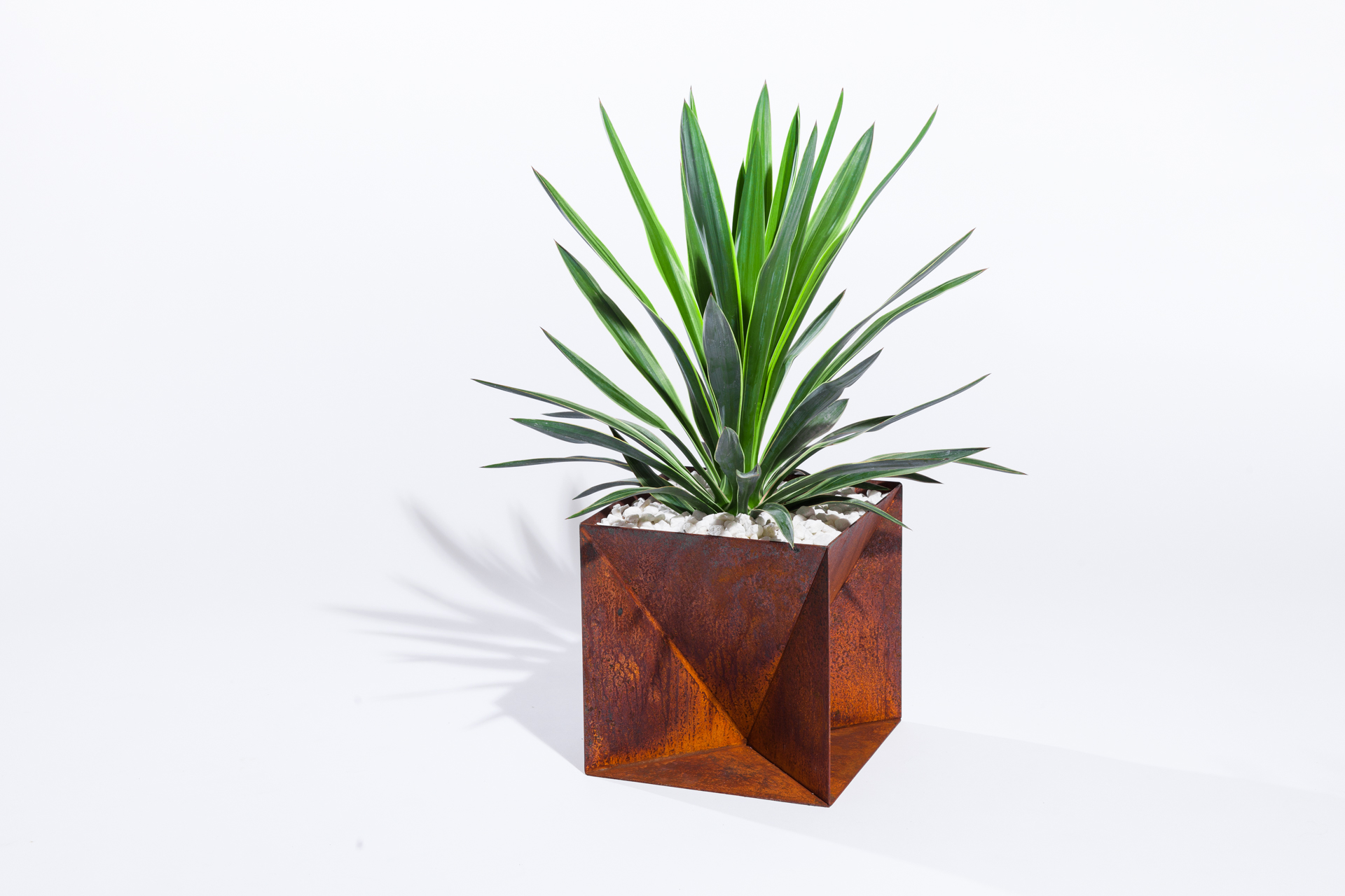 The Weathering Steel Origami Planter is an outdoor planter by Trey Jones Studio