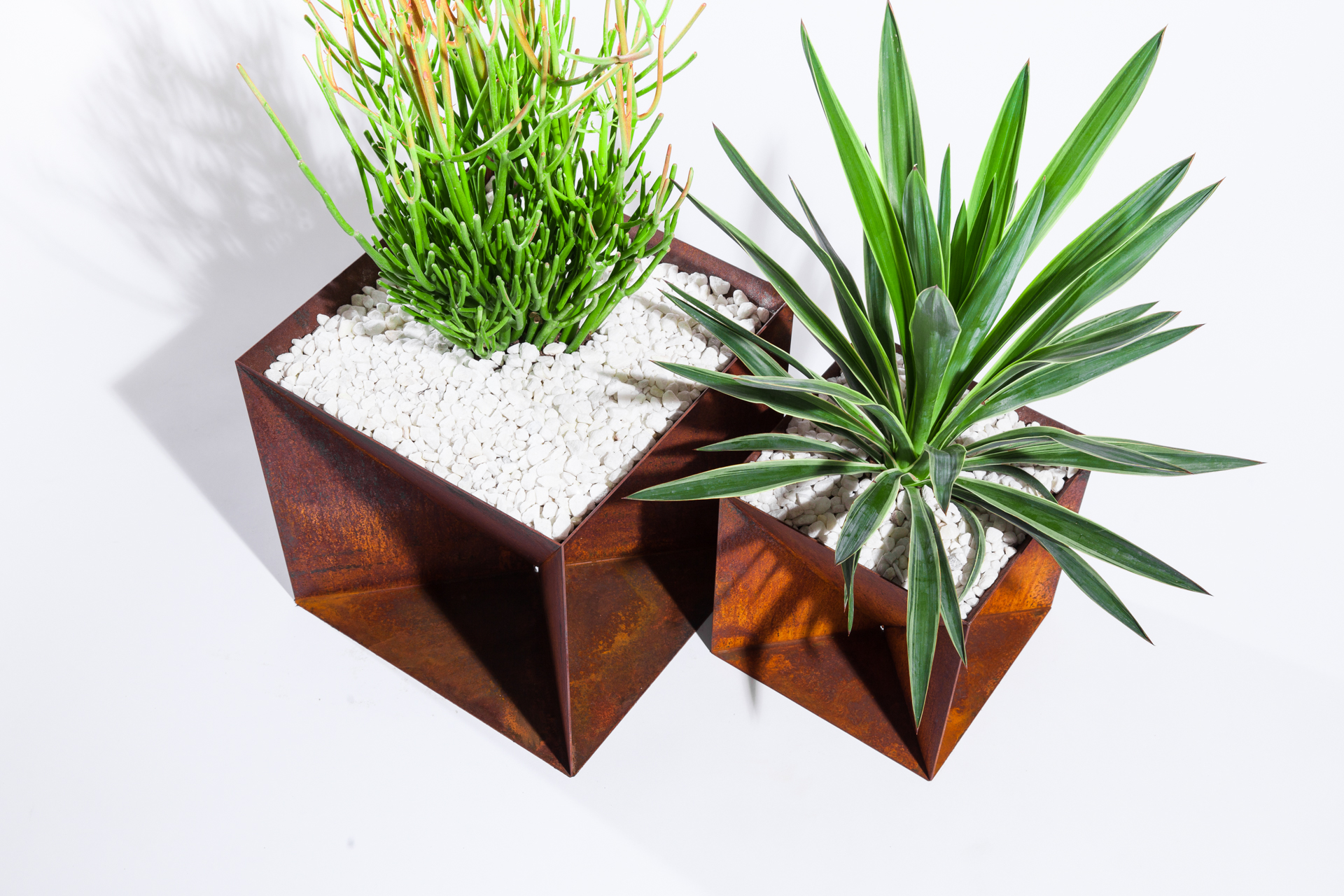 The Weathering Steel Origami Planter is an outdoor planter by Trey Jones Studio