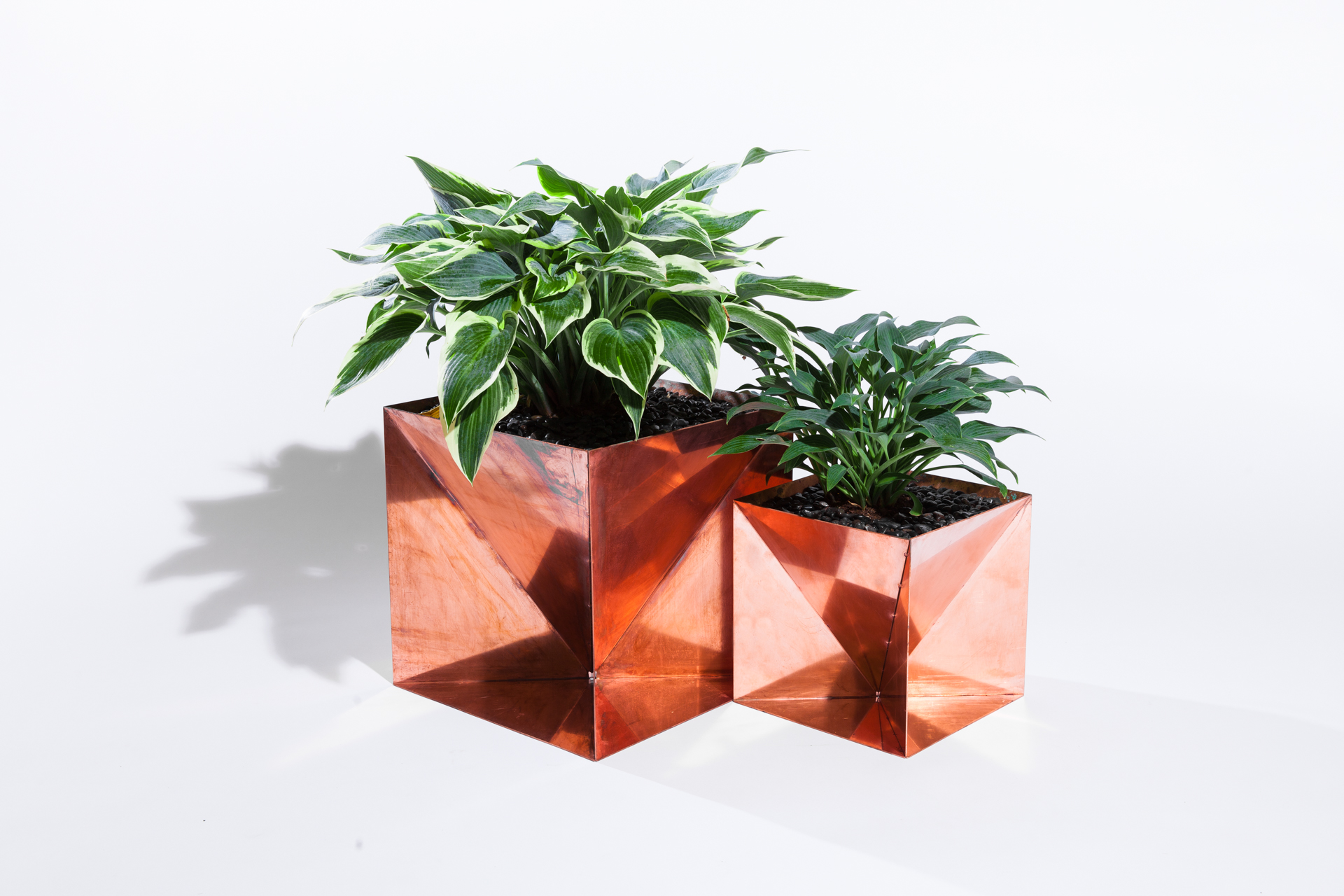 The Copper Origami Planter is an outdoor planter by Trey Jones Studio