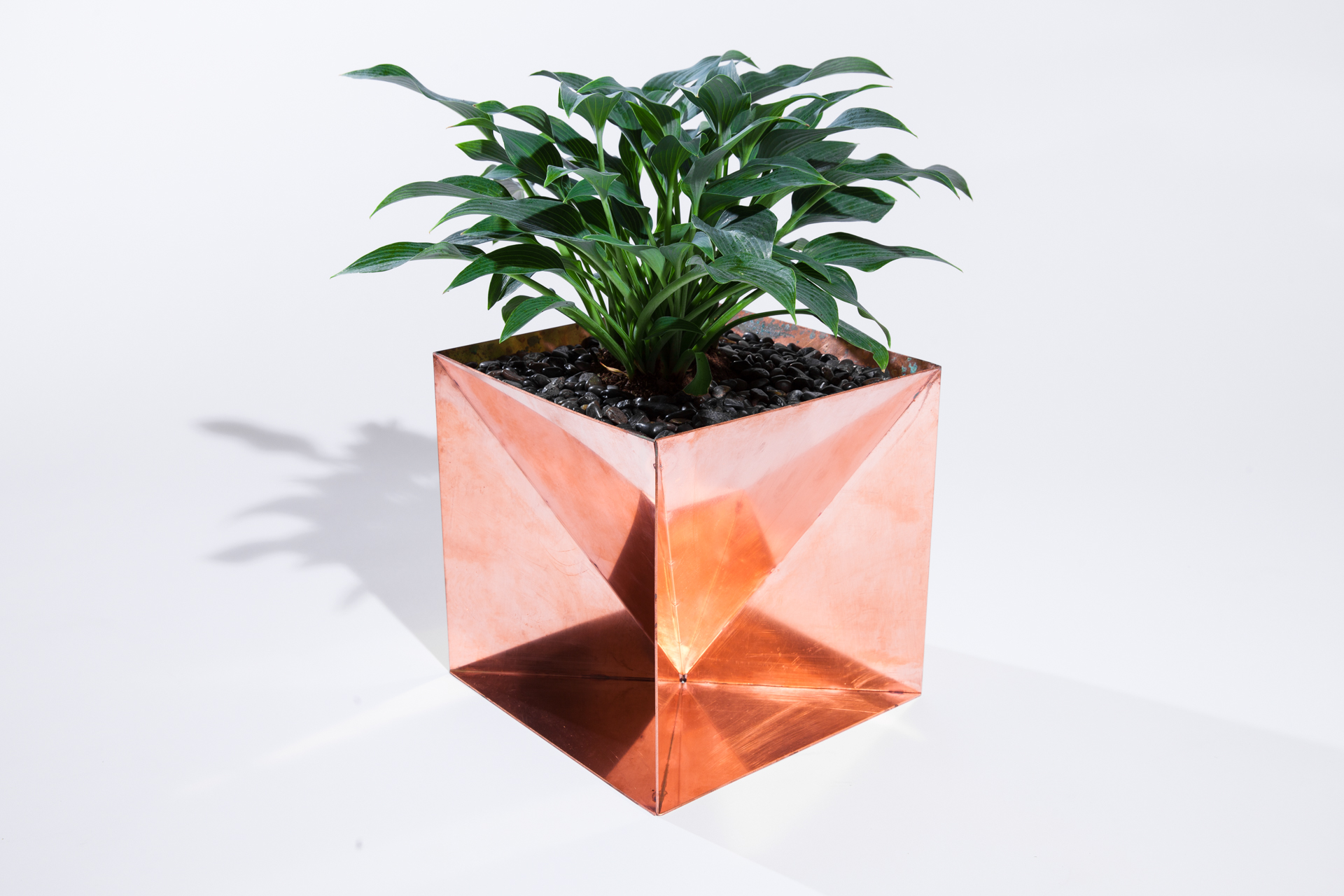 The Copper Origami Planter is an outdoor planter by Trey Jones Studio