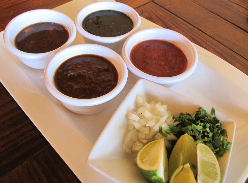 Top left - Salsa Habanero (habanero peppers, tomatoes, garlic, onions, cilantro) Top right - Salsa Quemada (roasted tomatoes, serrano peppers, garlic, onions and cilantro) Bottom left - Salsa Chipotle (roasted tomatoes, chipotle peppers, garlic, cilantro and oregano) Bottom right - Salsa Mild (tomatoes, oregano, garlic, serrano peppers and cilantro)