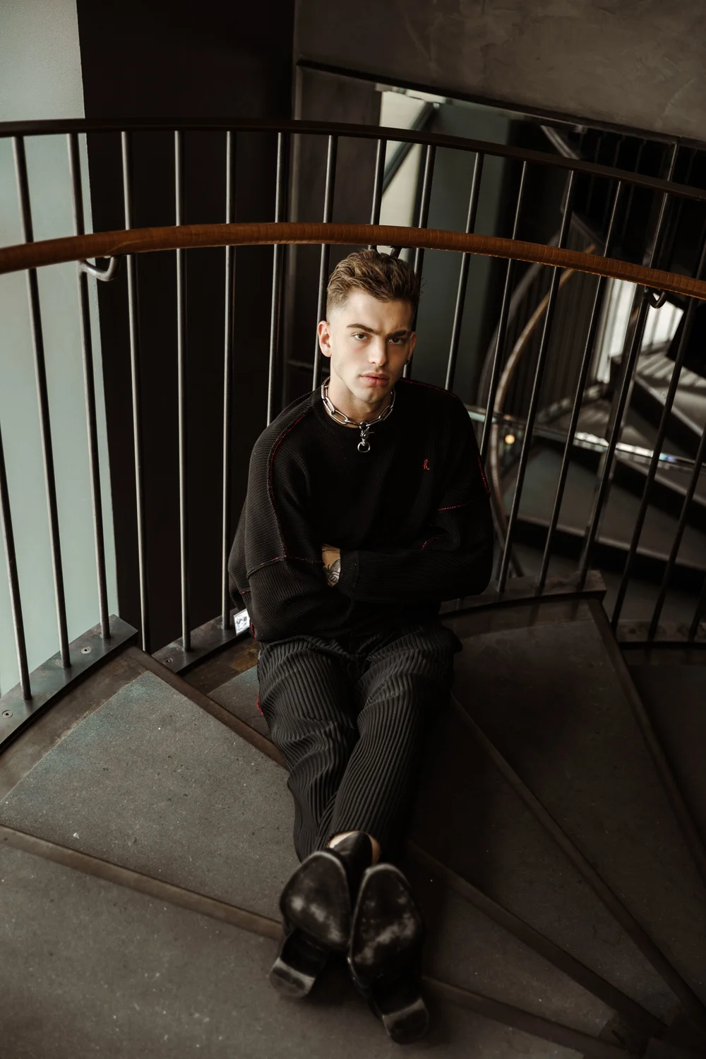 Raf Simons sweater, Issey Miyake pants, Saint Laurent boots all from FWRD Man
