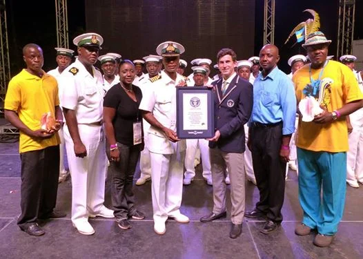 Captain Tellis Bethel, Deputy Commander Defence Force, receiving a certificate of confirmation from Guinness World Record Judge, Mr. Charlie Weisman, on behalf of the Bahamas Independence Committee with Mr. Chris Justilien (far right), the music director for the event, along with Defence Force marshals and officials. Photos courtesy of the Royal Bahamas Defence Force