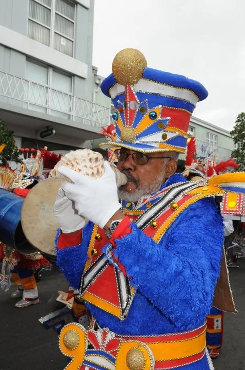 Creative Nassau Founder, the late Jackson Burnside III, blowing his conch shell during a Junkanoo parade on Bay Street, Nassau