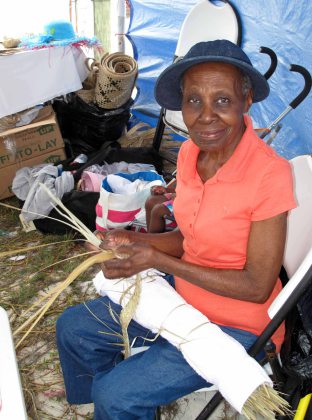 Straw worker, Rose McKenzie, weaves dried strips of palm fronds into plait