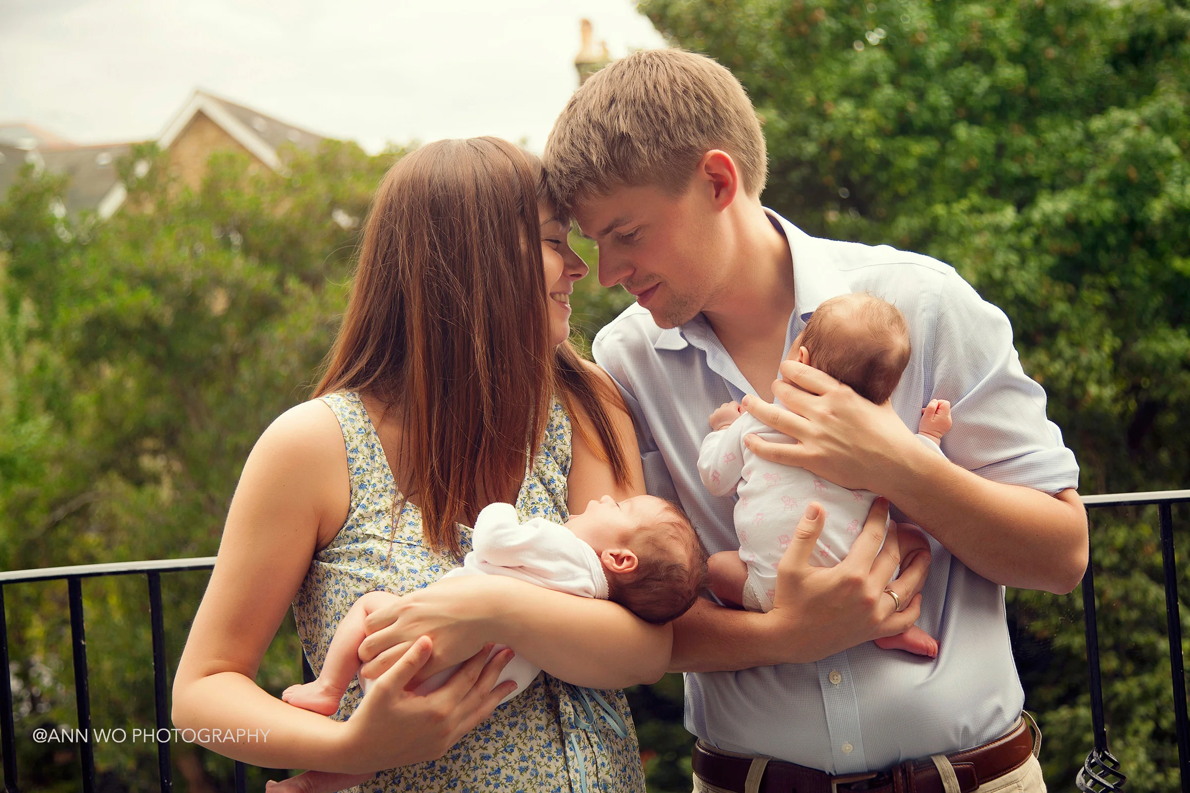 newborn twins with parents