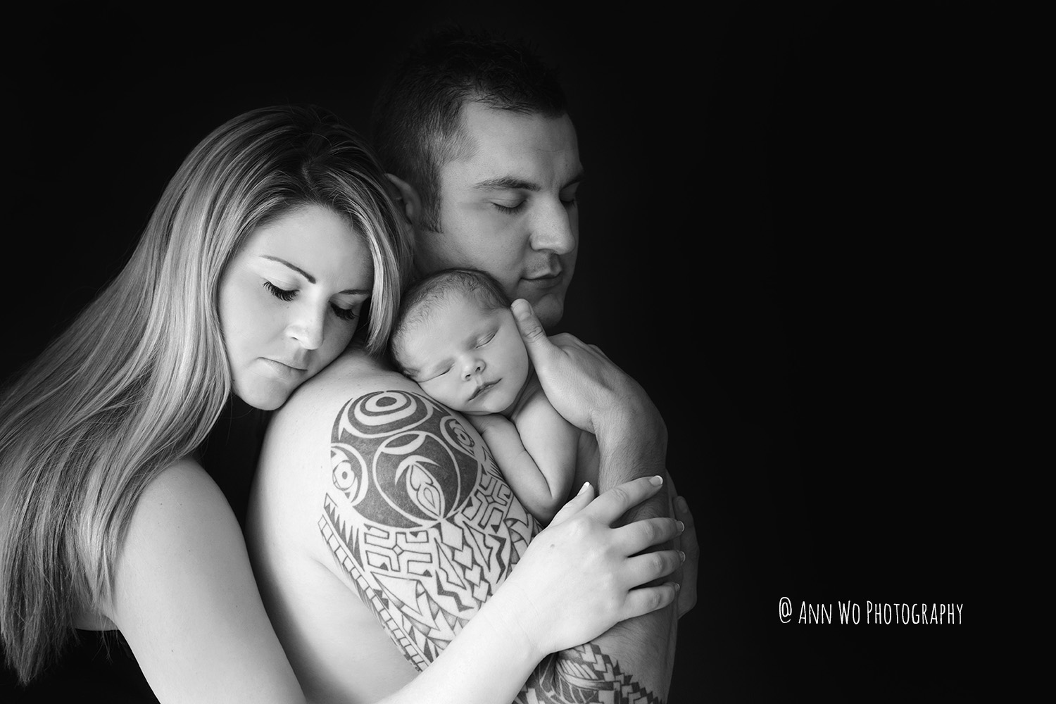 newborn baby skin-to-skin with mum and dad