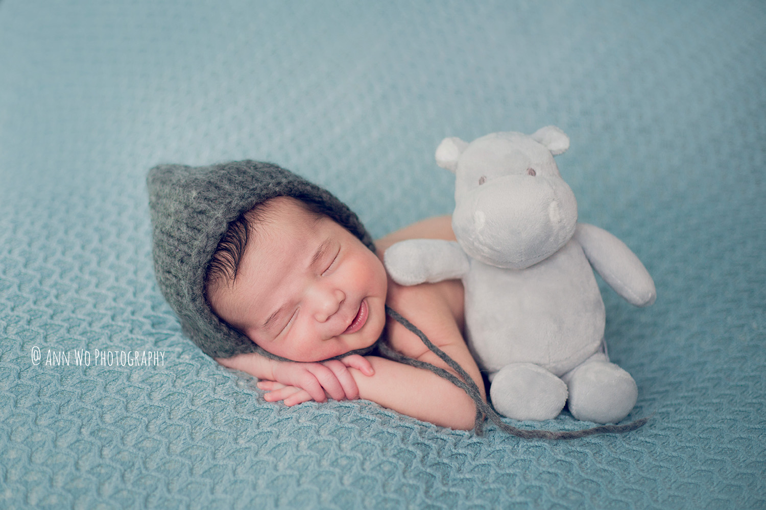 adorable newborn baby smiling by Ann Wo photography in London