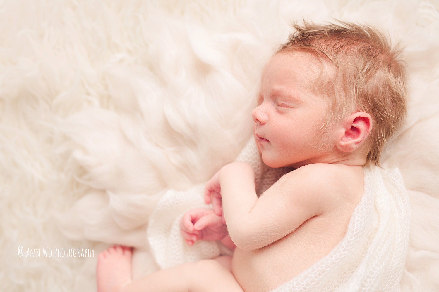 newborn baby in cream cozy set up - Ann Wo Photography London