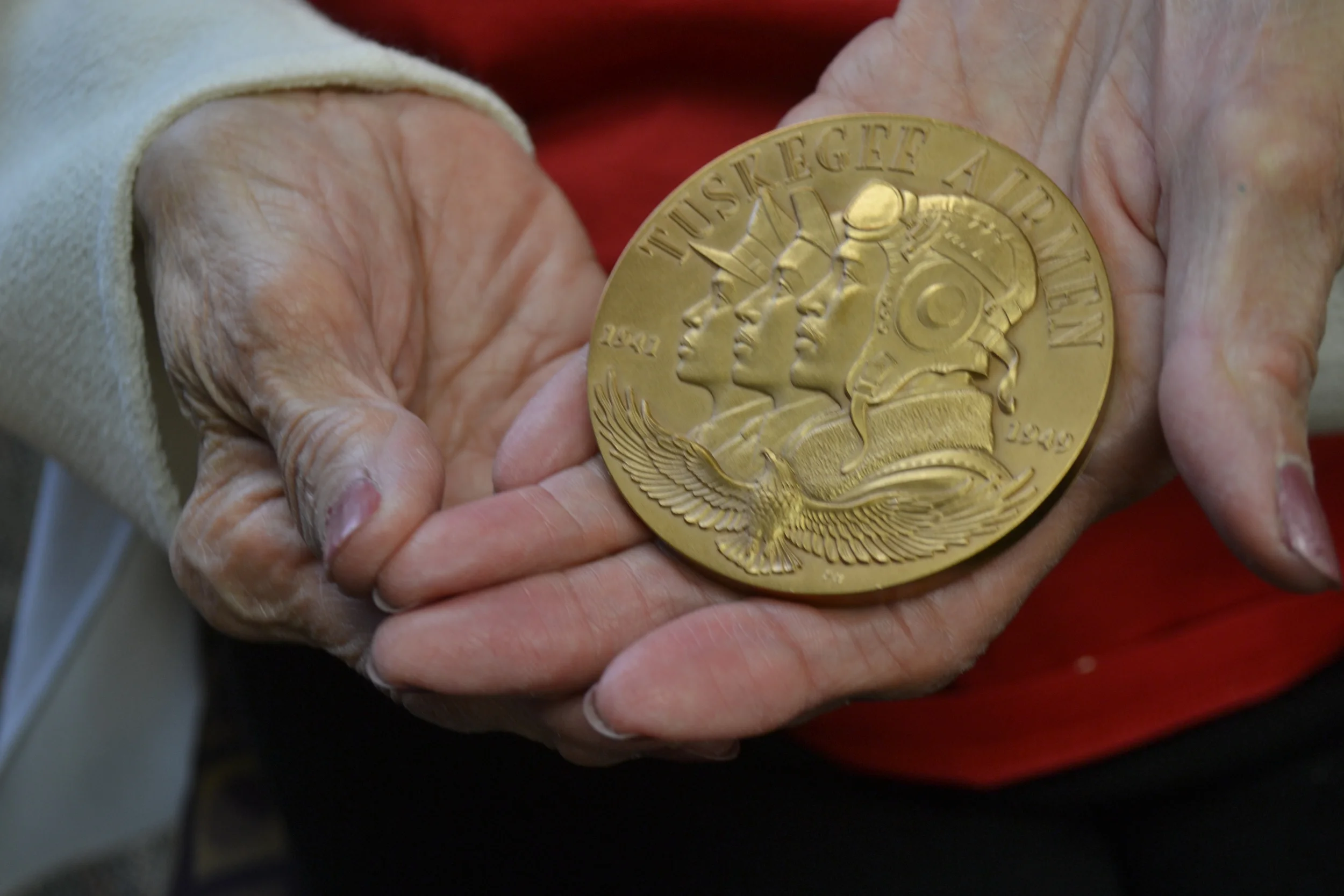  Cozette
 Washington holds her husband Miles's Joint Base Myer-Henderson Hall 
Command Team coin. Miles Washington enlisted in the Tuskegee Airmen 
program in 1944. World War II ended while he was still in training, but 
he would then serve in the Ai