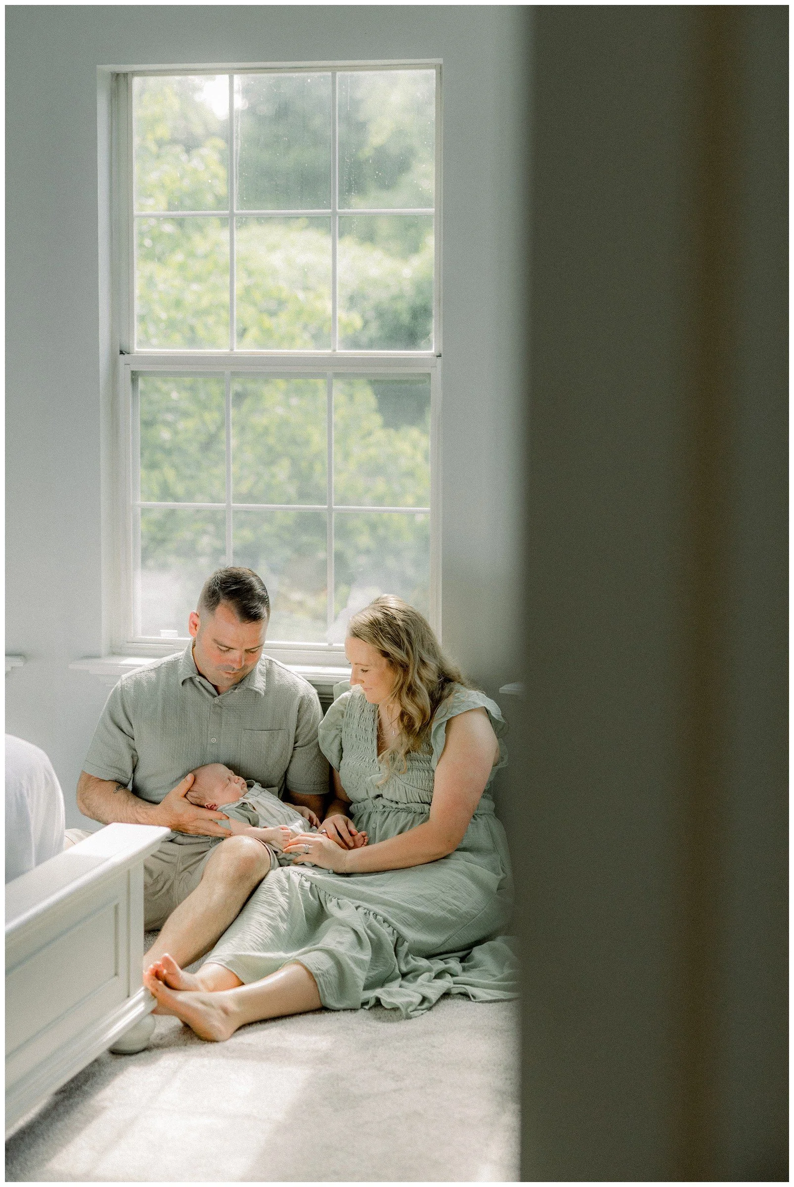 newborn-with-parents-by-window.jpg