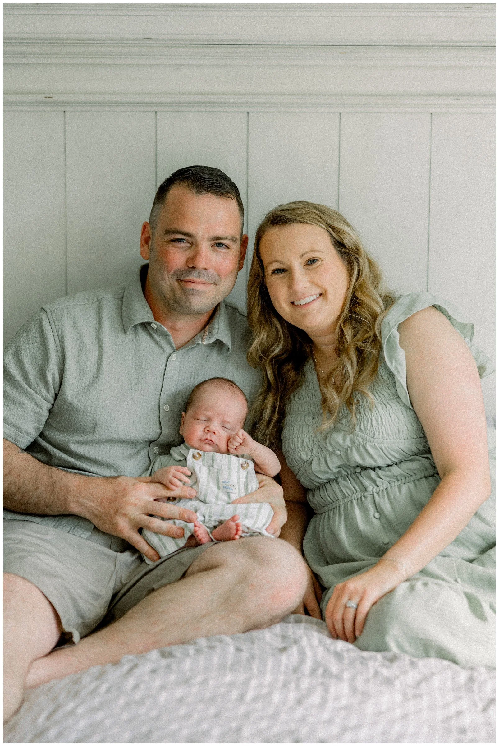 parents-on-bed-holding-newborn.jpg