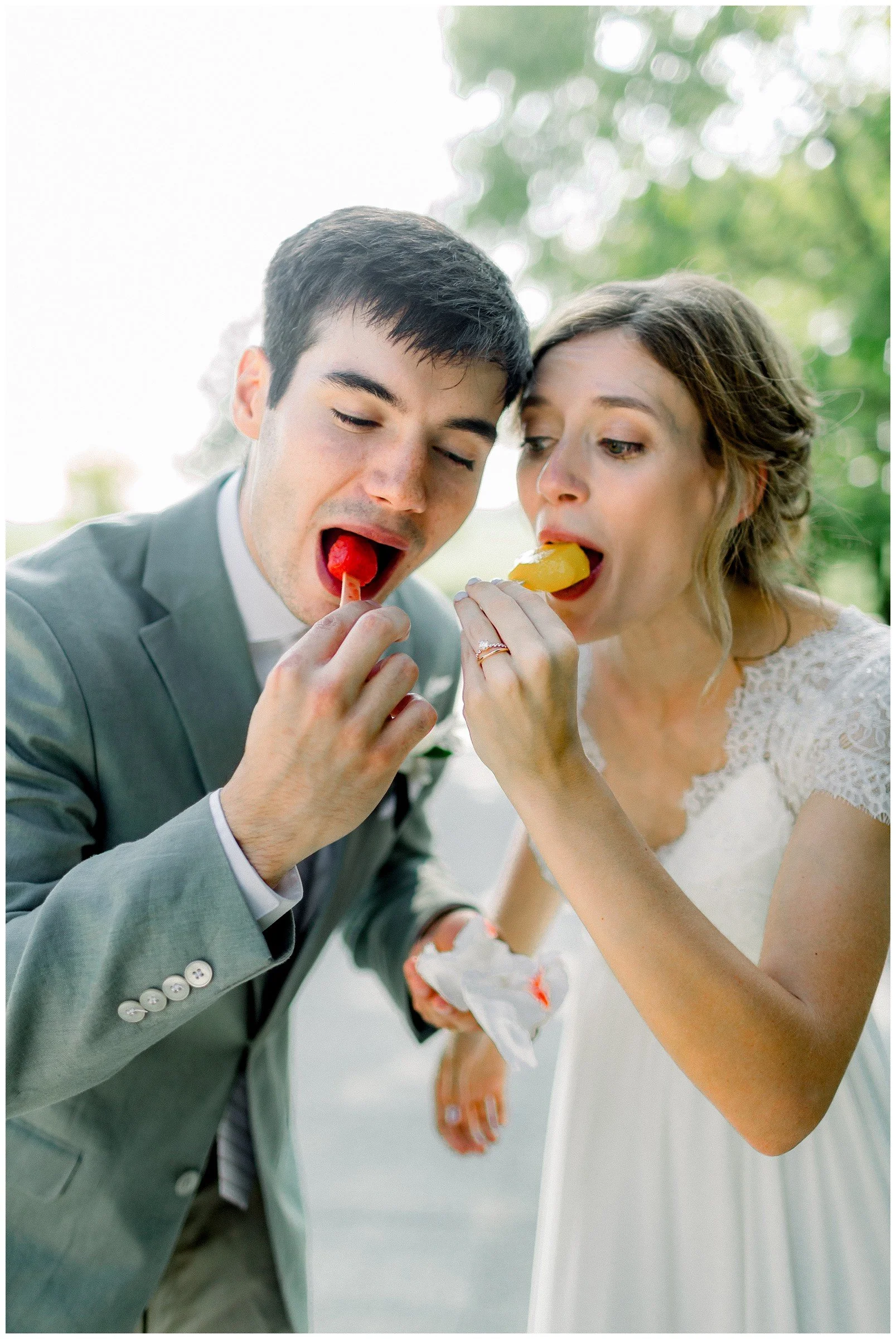 bride-and-groom-eating-popsicles-at-wedding.JPG