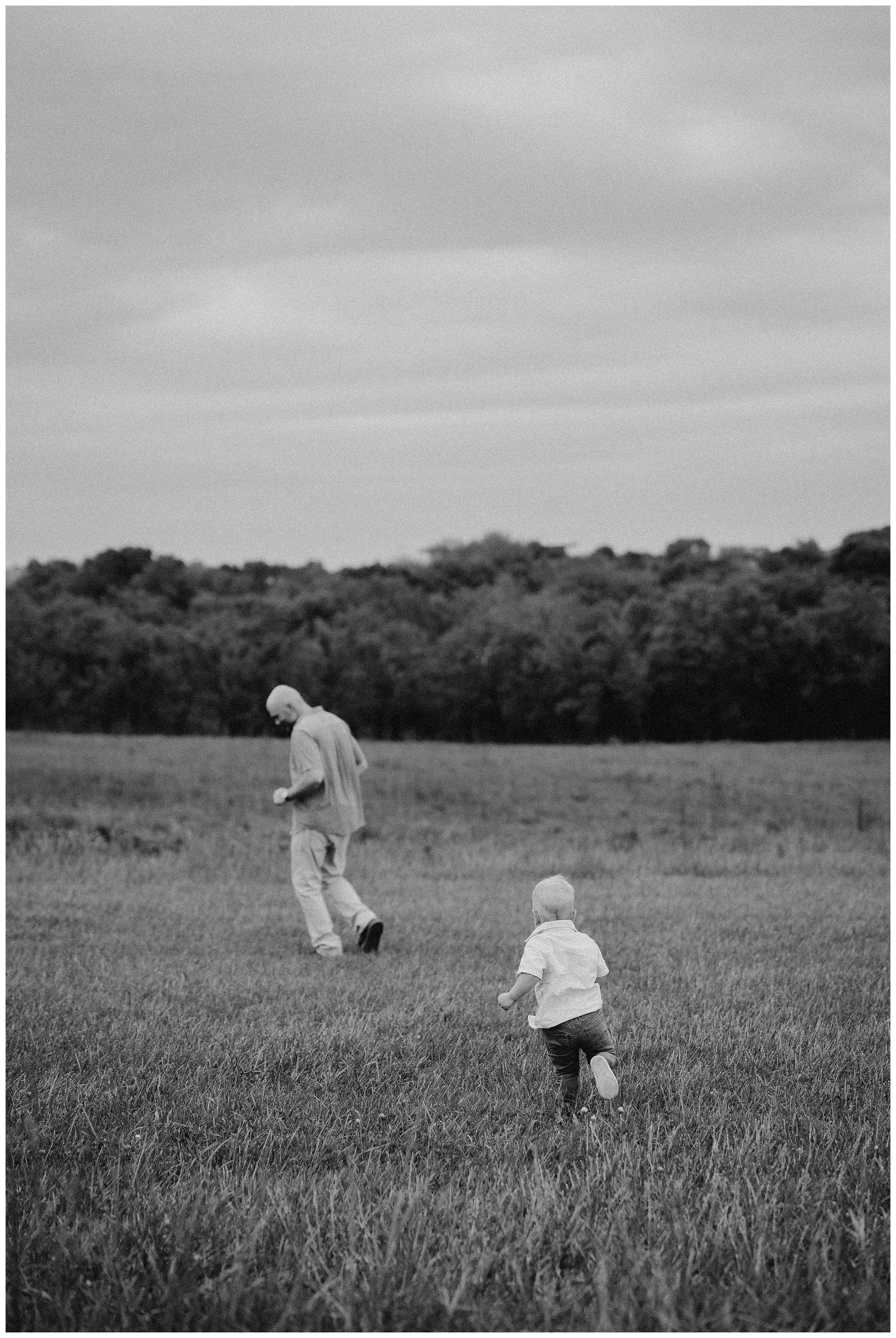 toddler-boy-running-to-dad-in-field.jpg