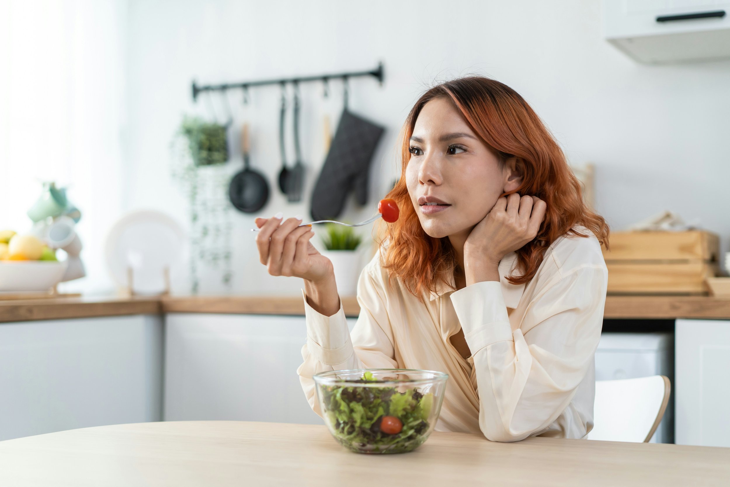 Woman eating, not satisfied, keeps thinking about food.