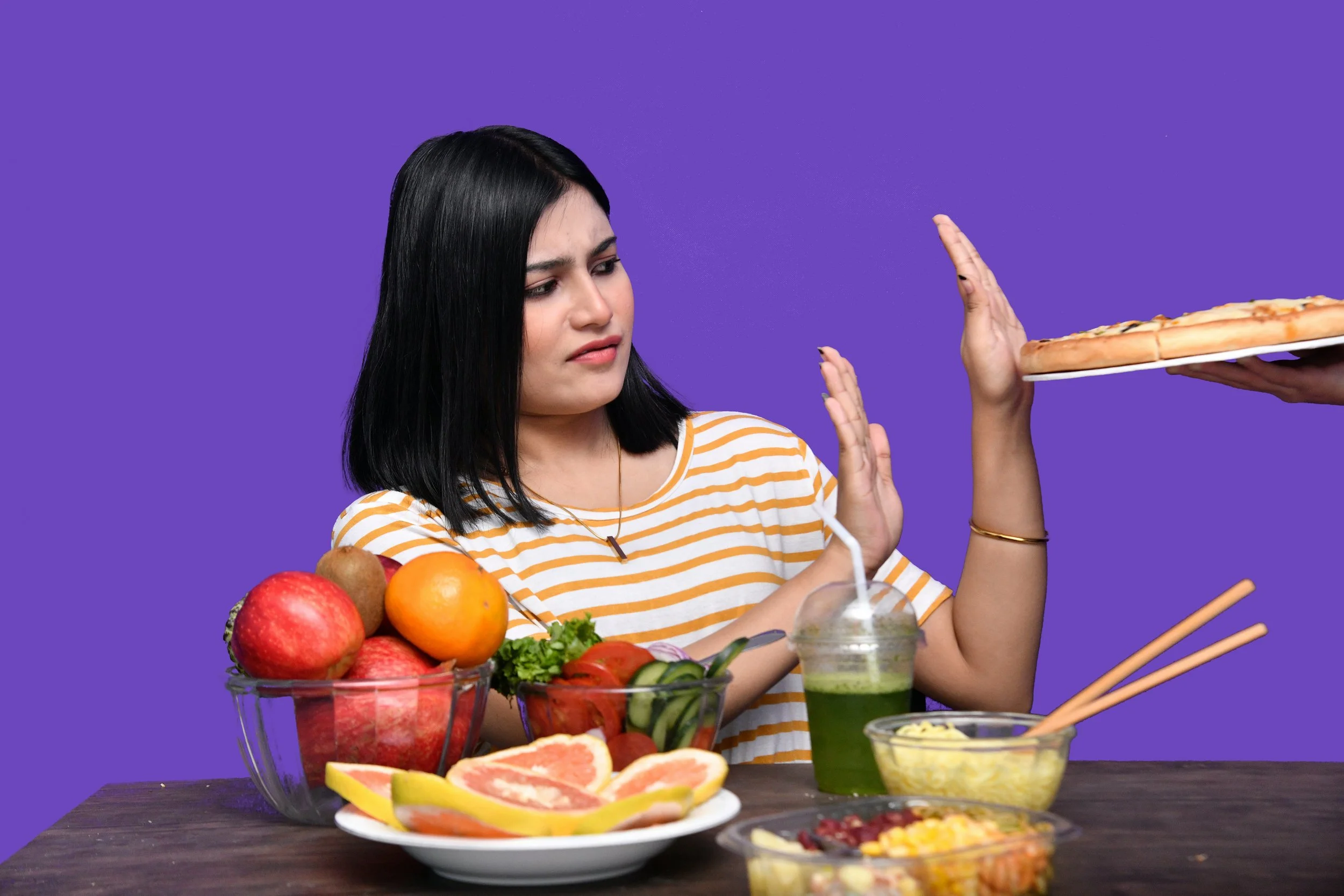 A woman refusing food she wants, instead eating low calorie food, causing her to think constantly about food.