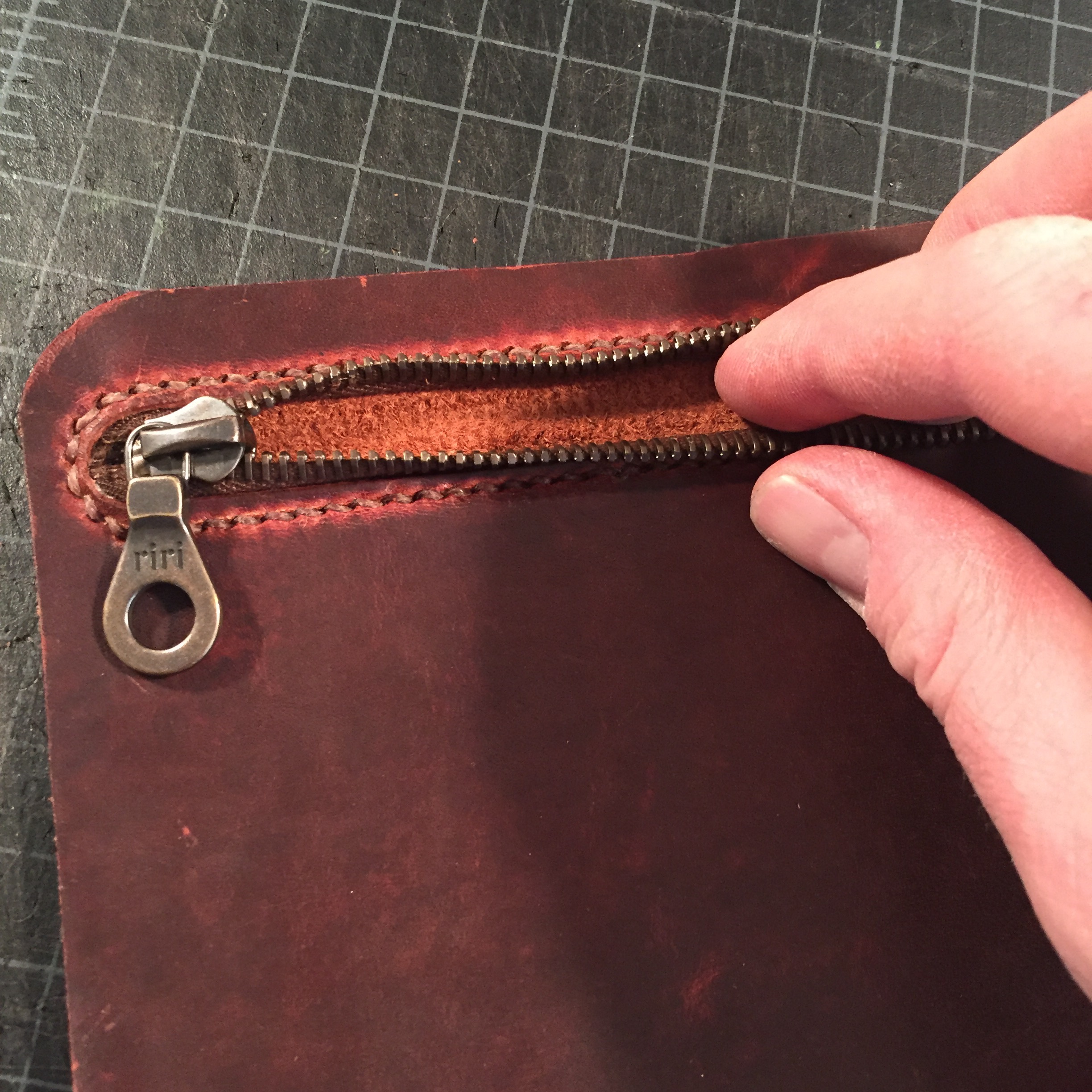 I make a little cut from the zipper side so I know where to start my cut on the other (lining) side. 