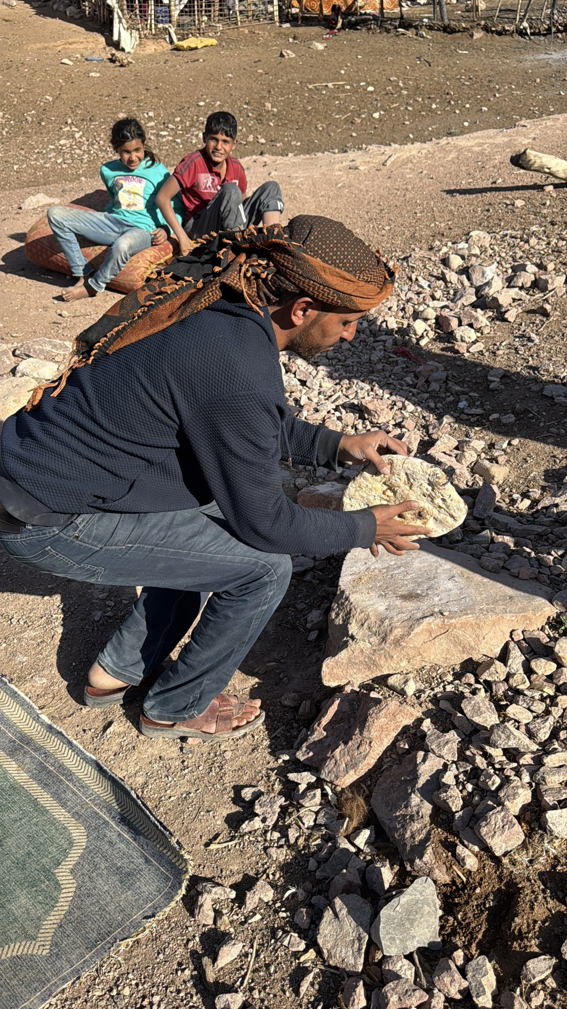 When we asked our guide, also called Amin, how he knew when the bread was ready, he tapped on it with his stick. He told us he could hear the sound and knew the feel of the bread when it was done. To remove the ashes he picked up the loaf and slammed