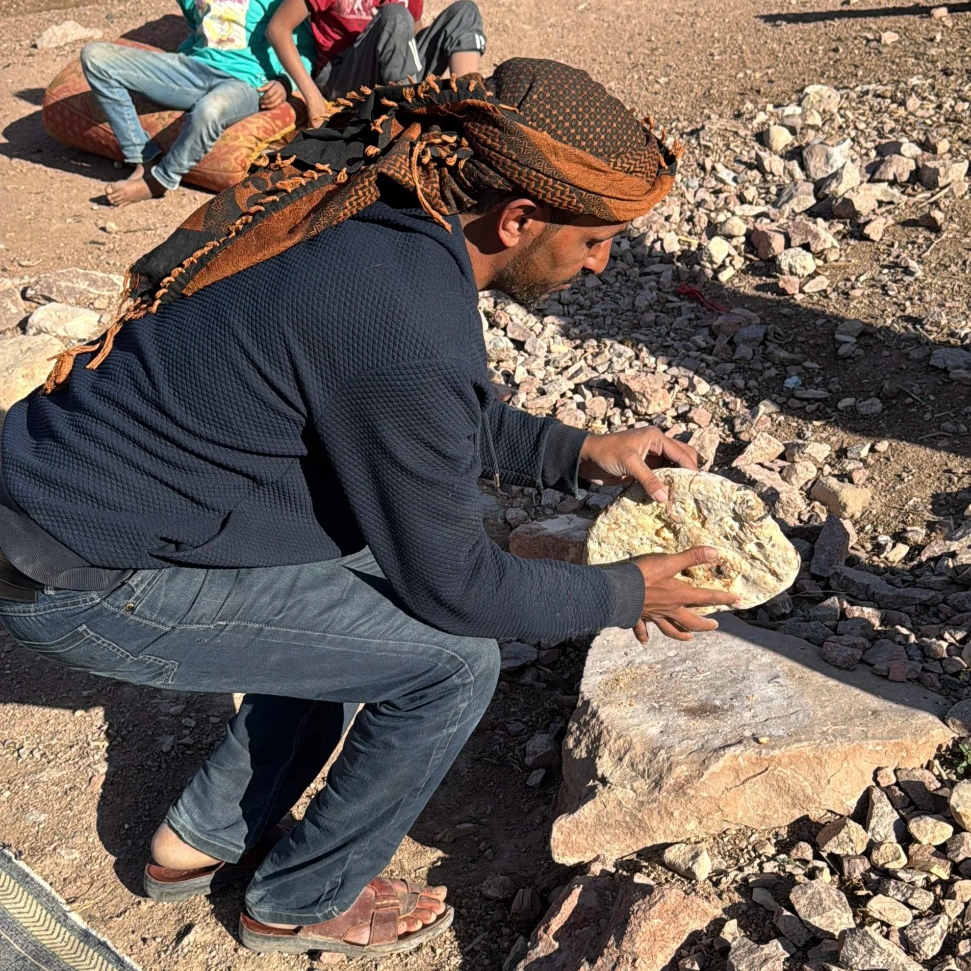 When we asked our guide, also called Amin, how he knew when the bread was ready, he tapped on it with his stick. He told us he could hear the sound and knew the feel of the bread when it was done. To remove the ashes he picked up the loaf and slammed