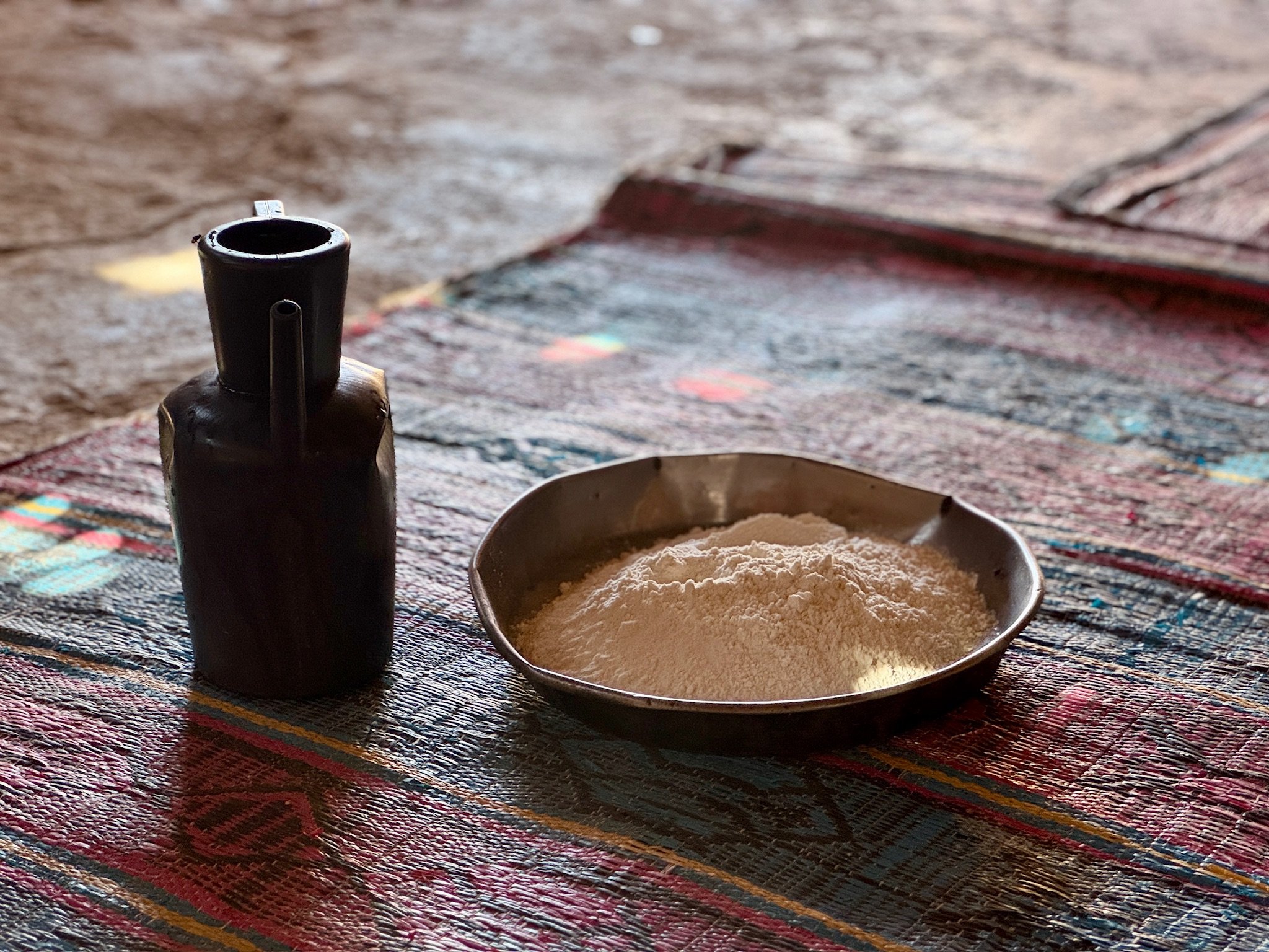 Set on the floor were two vessels, one holding the flour and the other the water to make the bread. 