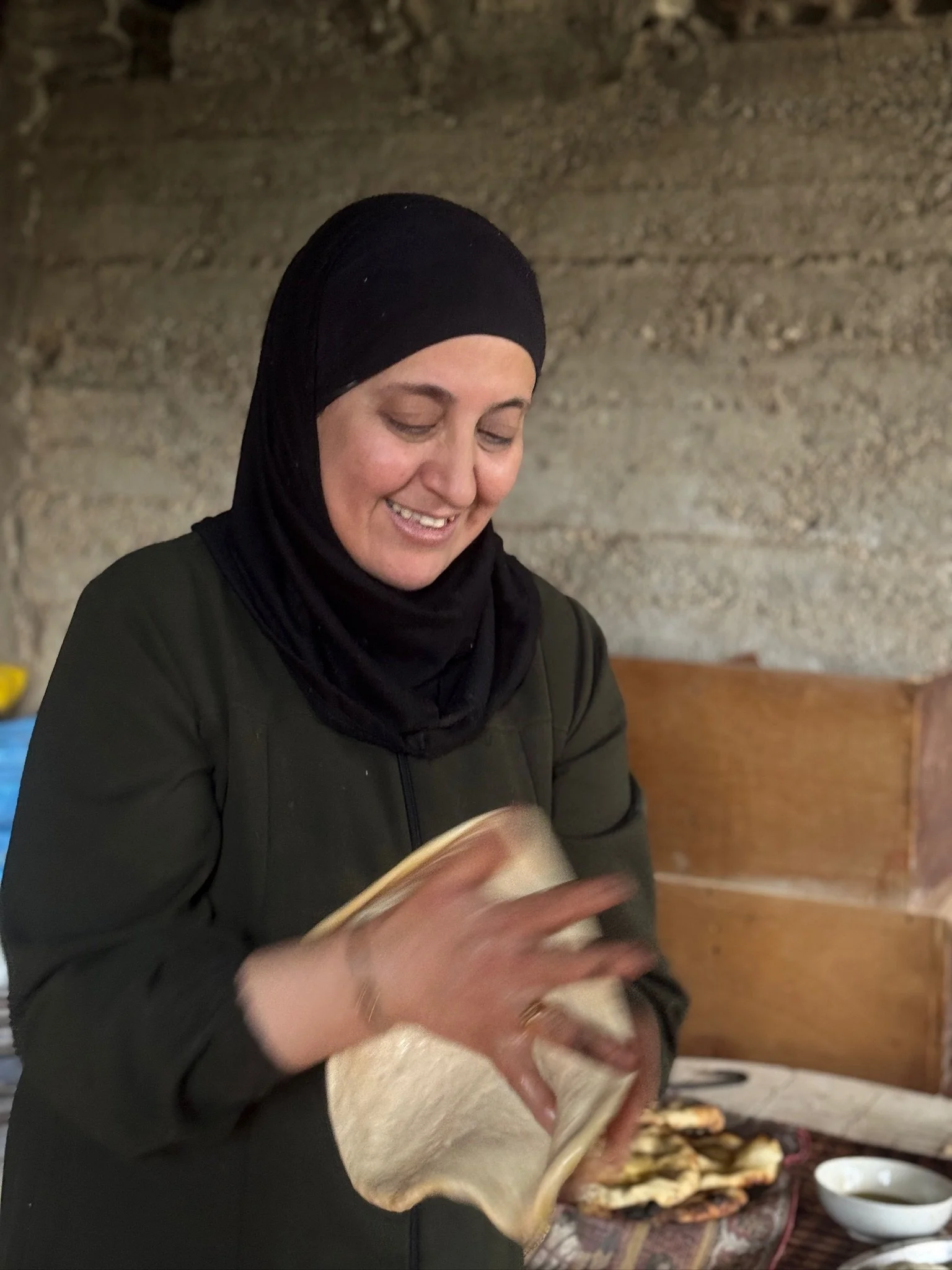 Then came the most challenging step. Reema rapidly slapped the dough between her open palms, stretching it thinner and thinner. It looked simple. It was not. Too much force and the dough would tear. Too little and it would not open.