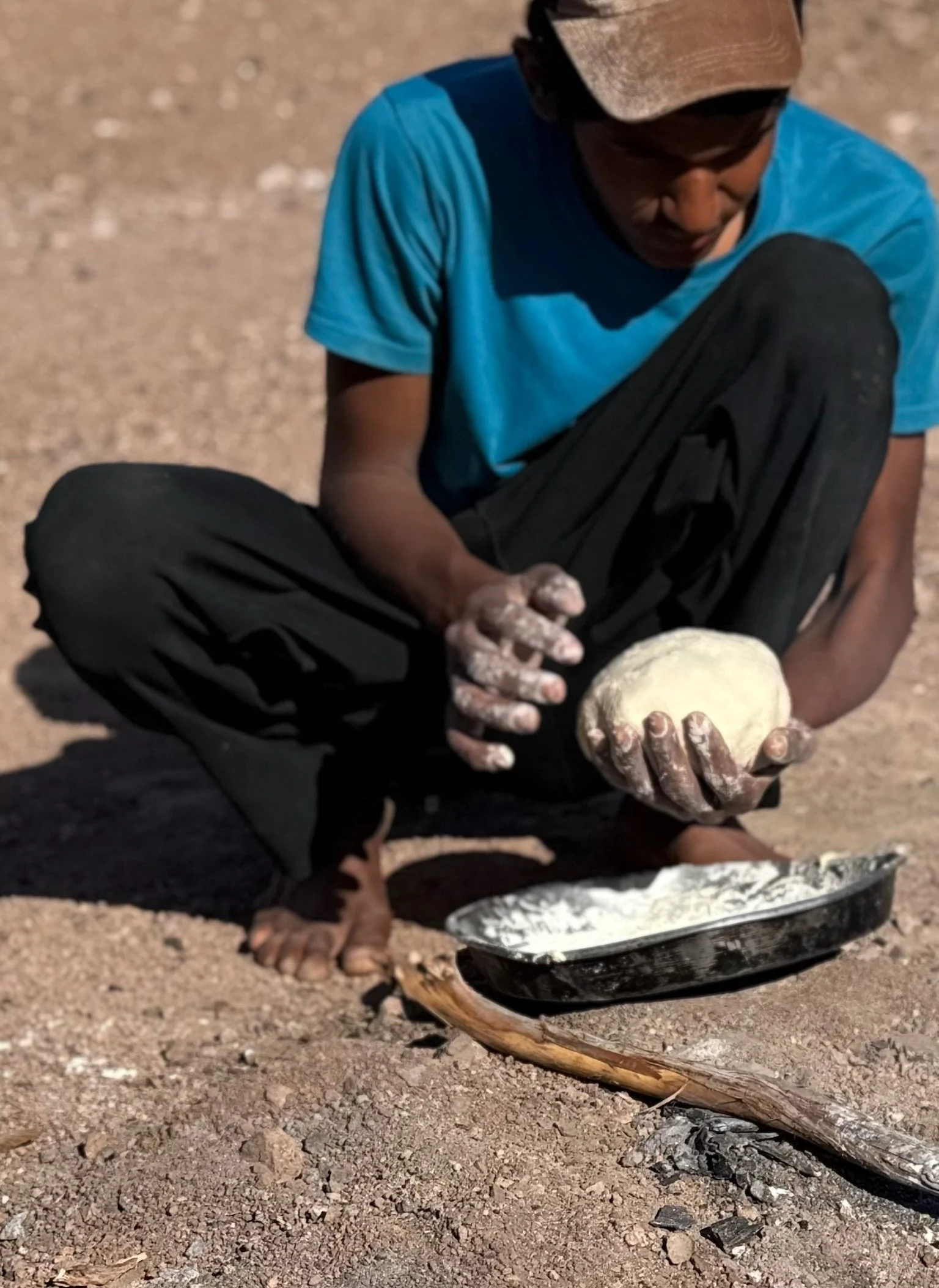 We walked outside where a fire had been prepared and had burned down to ash and embers.