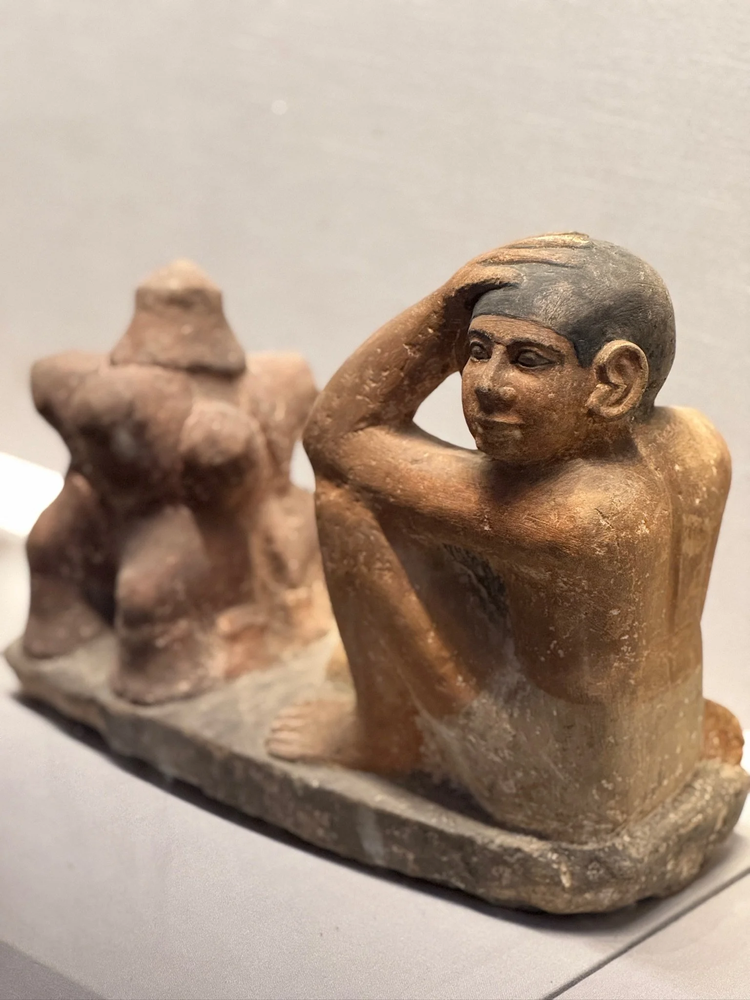 A baker protecting his face from the heat of the oven.