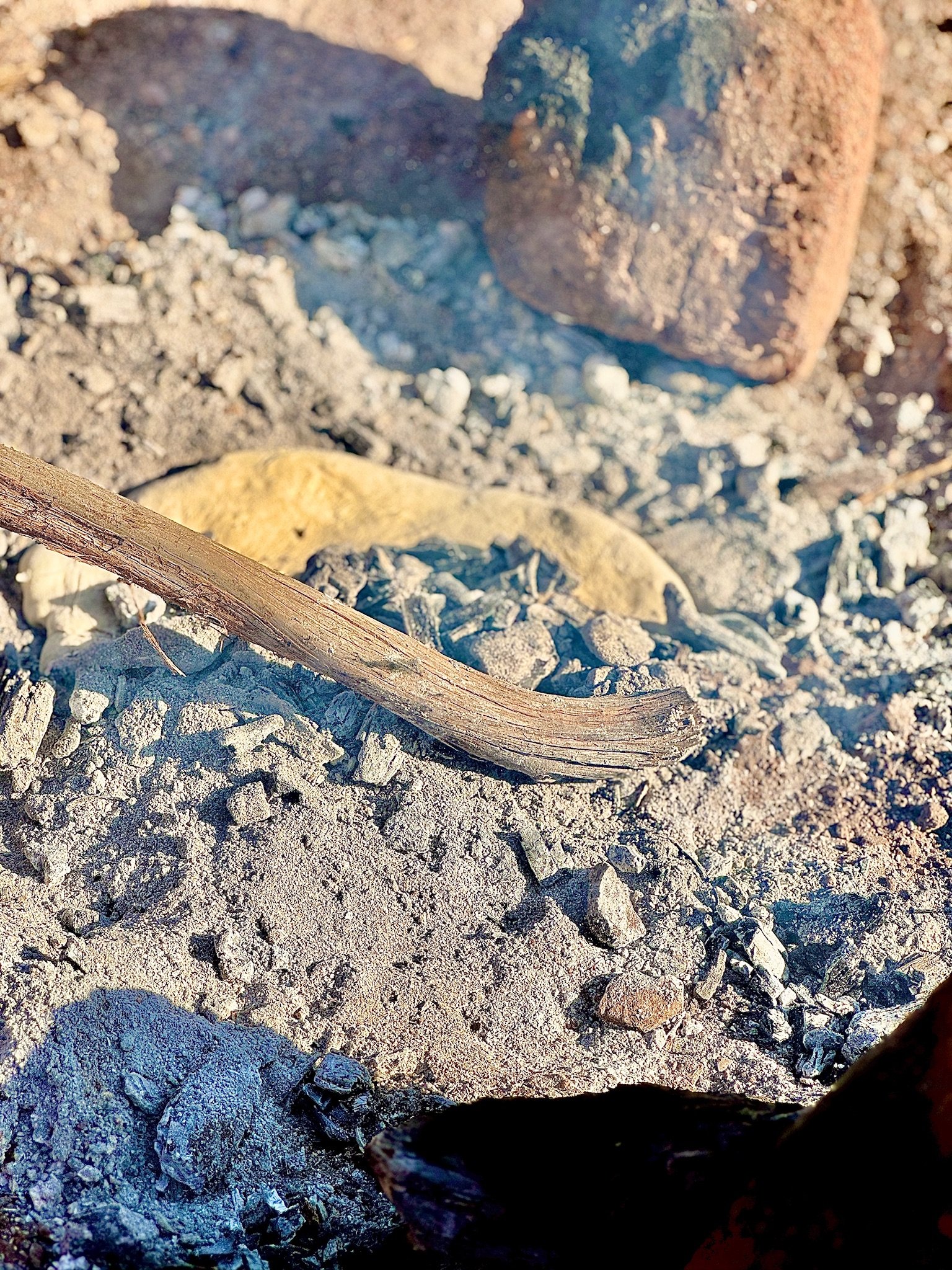 Next the dough is buried in the ash and embers.