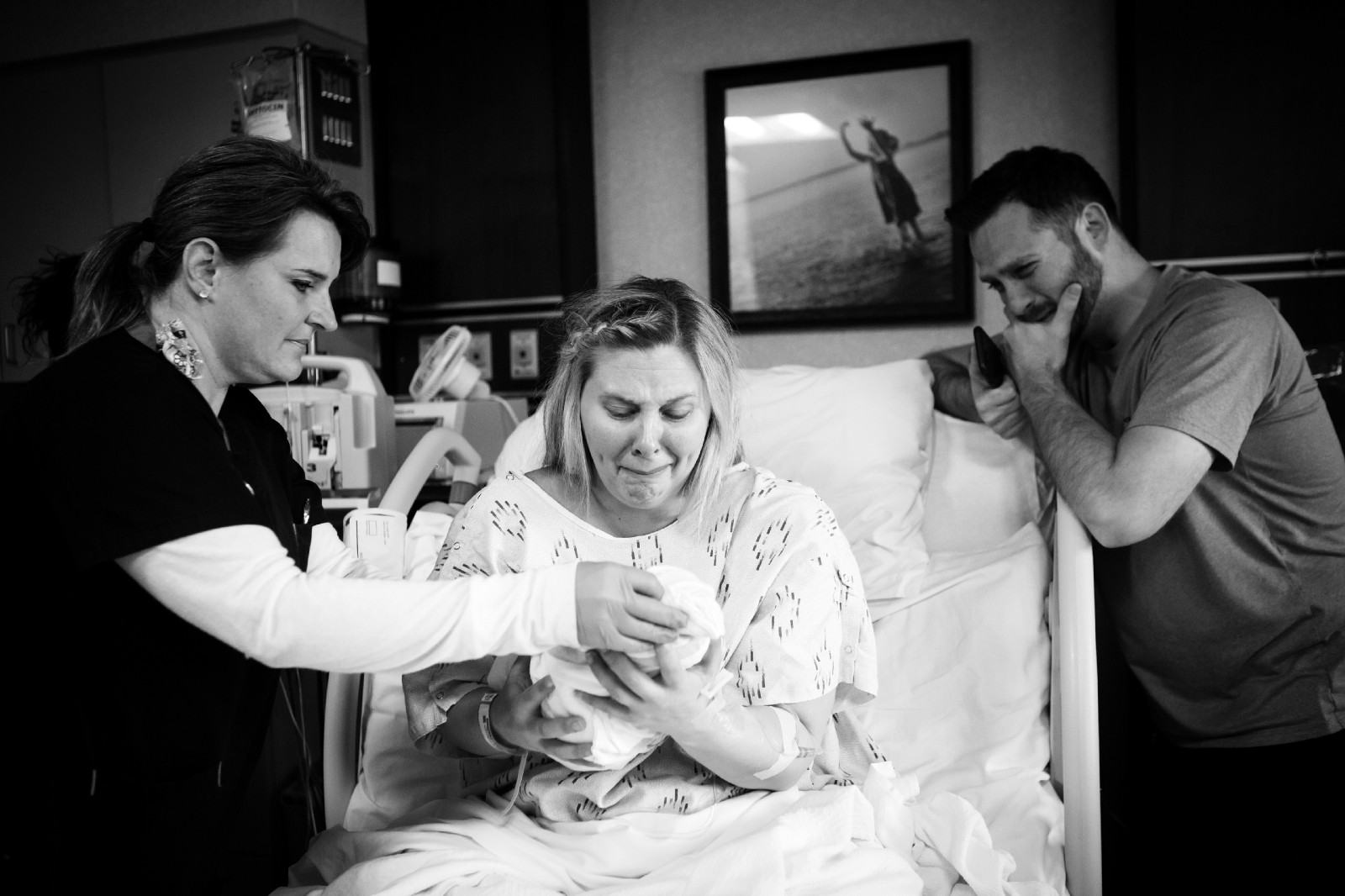 Keri and Royce Young meet their baby Eva for the first time. (Photo credit to Mitzi Aylor/Aylor Photography)