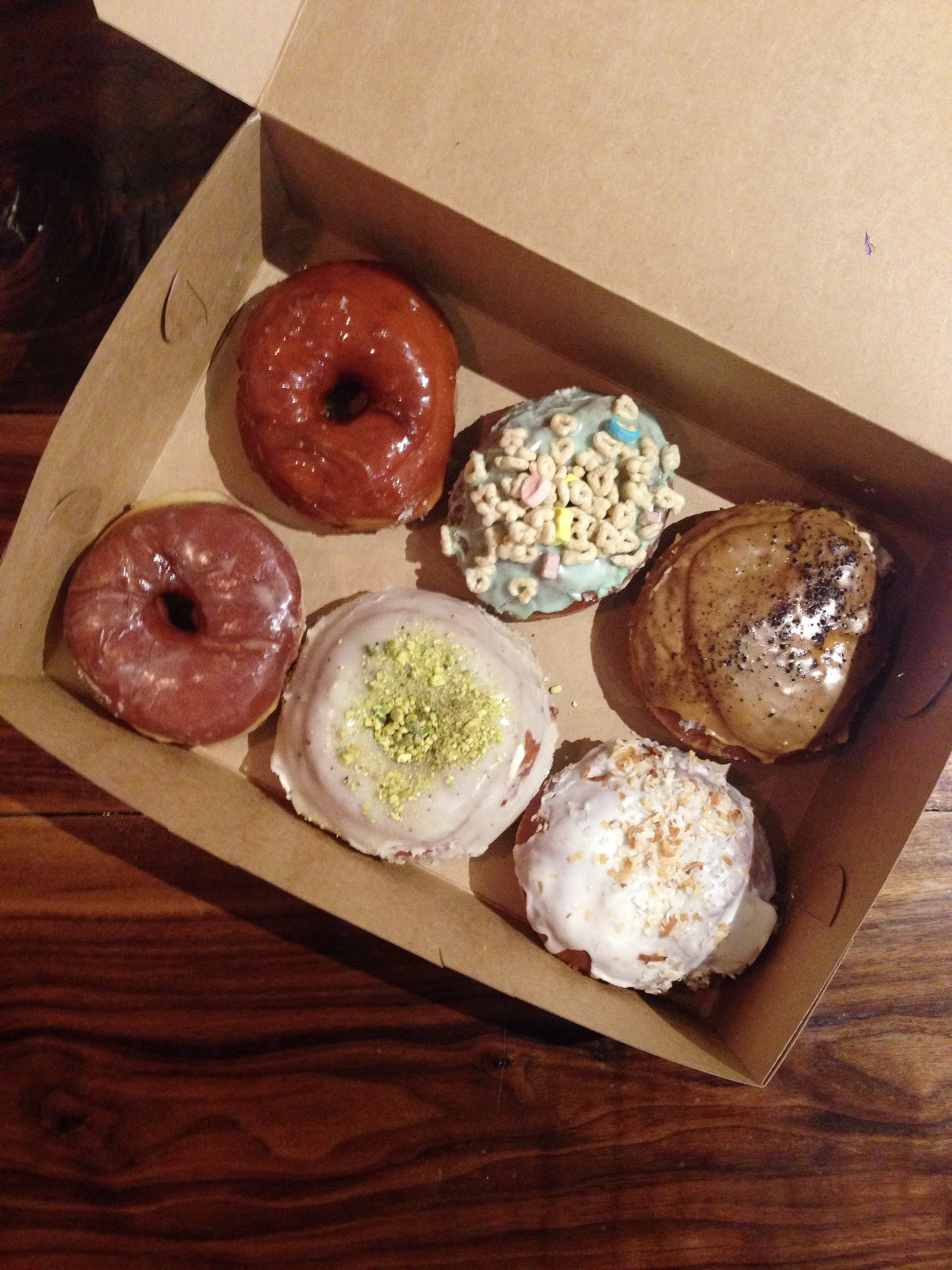 Clockwise from the top: Salted Caramel, Lucky Charms, Vietnamese Iced Coffee, Glazed, Brown Butter Pistachio, Coconut Cream.