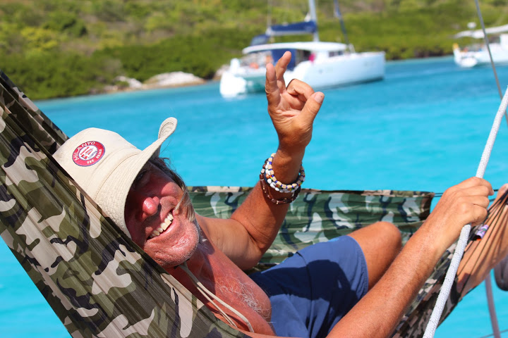 VALERIO IN THE HAMMOCK ON BOARD MILANTO IN THE CAYS
