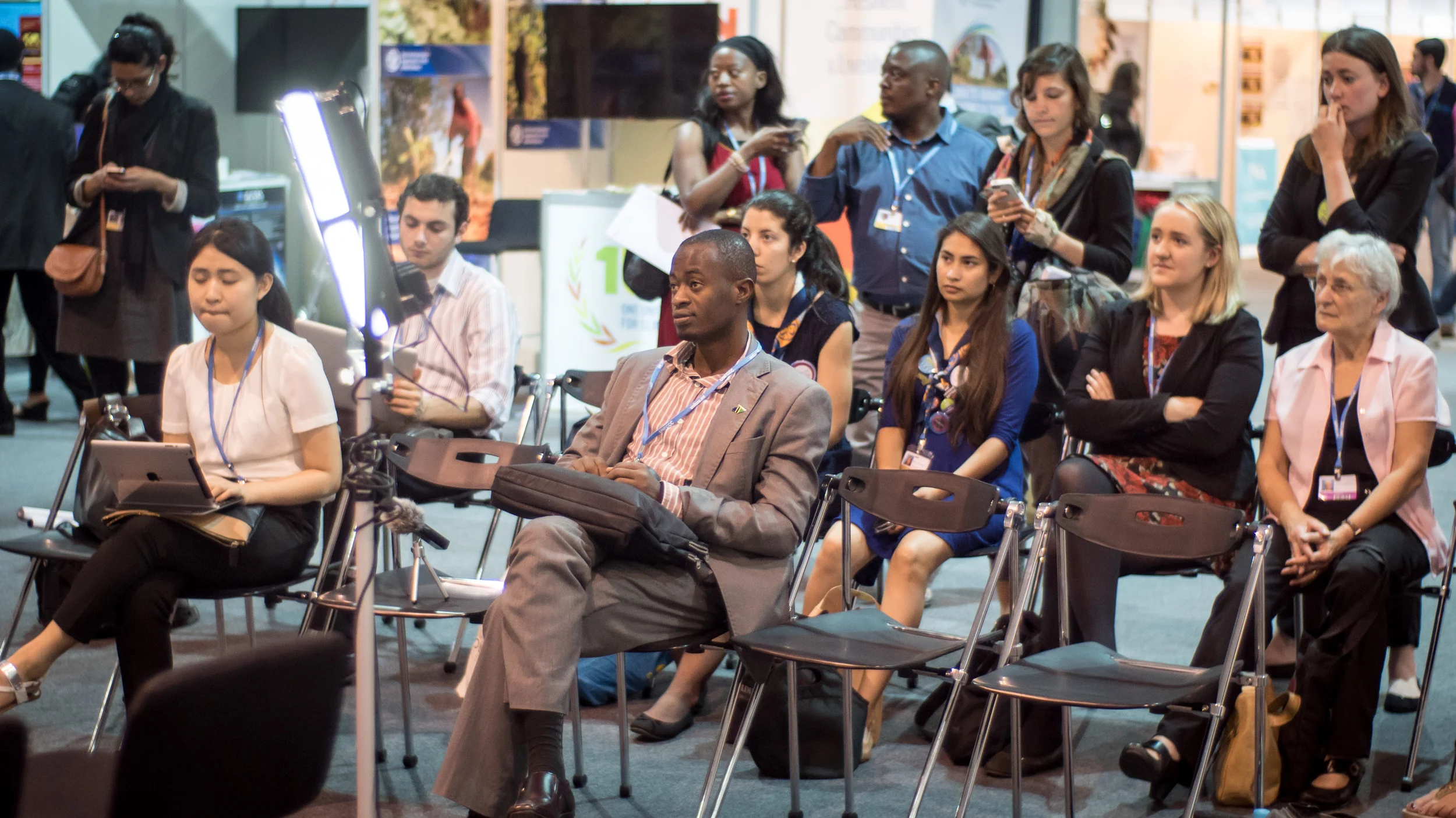 Youth engage in discussions around the conference centre.