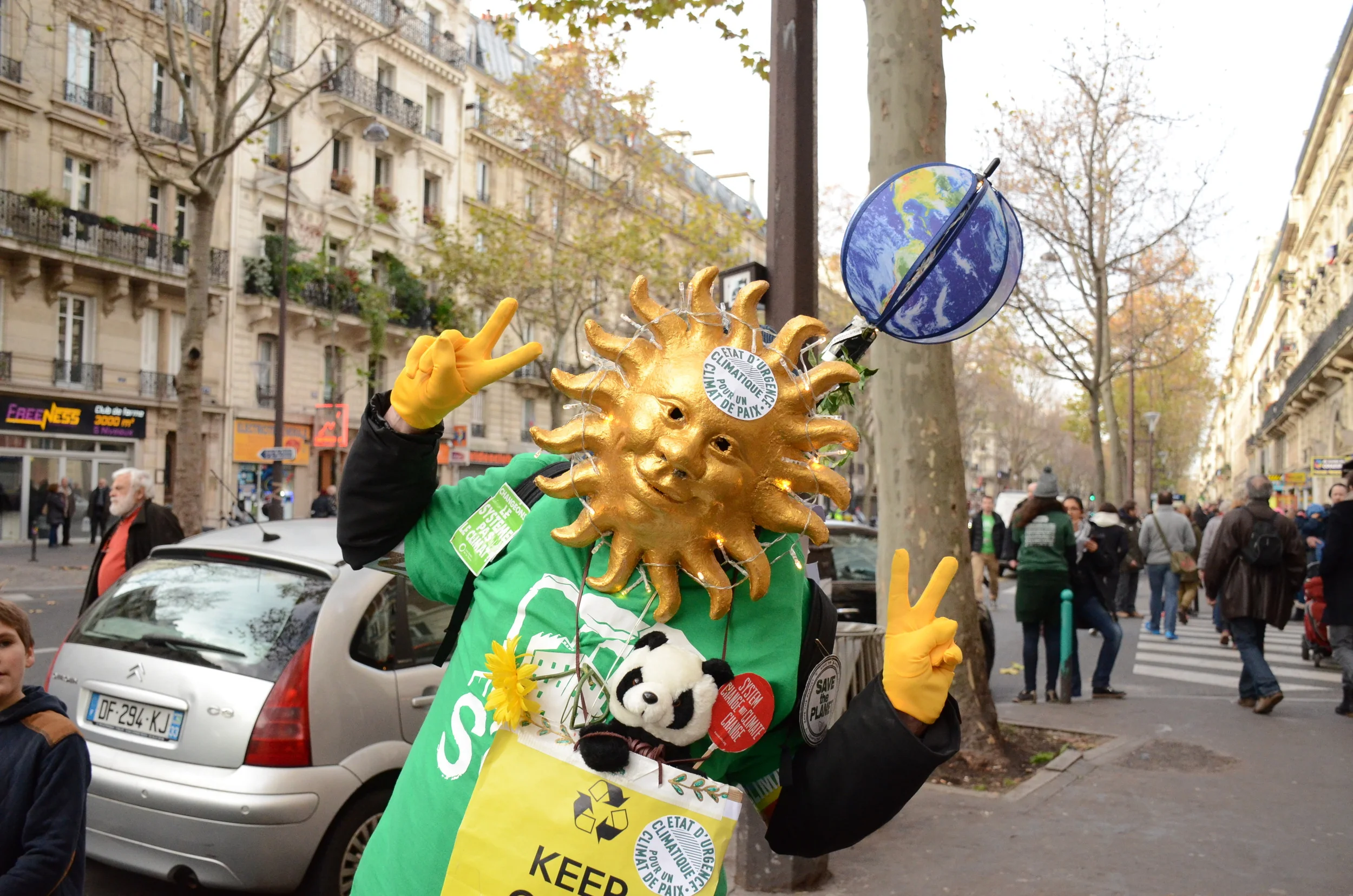 A demonstrator sports a costume with an environmental message as he walks along Boulevard Voltaire.