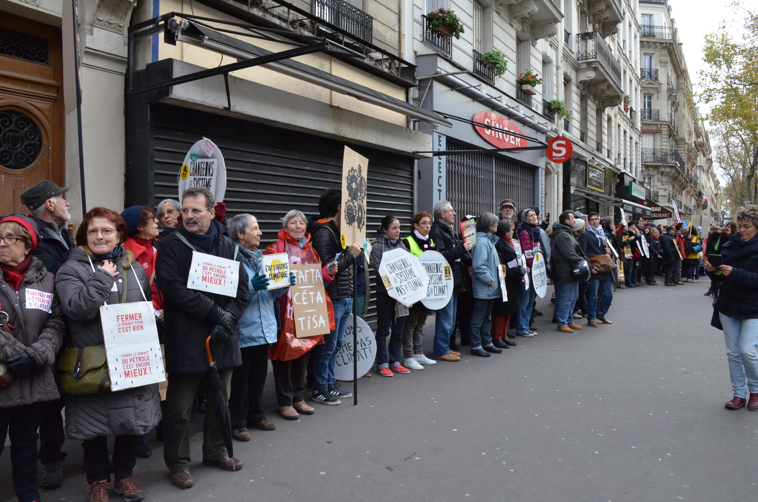 Demonstrators form a human chain along Boulevard Voltaire, marking the 3km-long route of the banned march.
