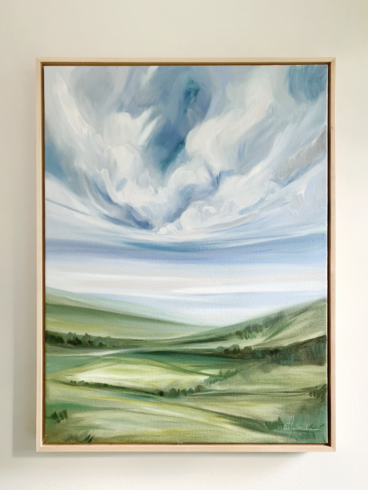 A landscape painting of green farmland and rolling hills under a sky with swirling clouds.