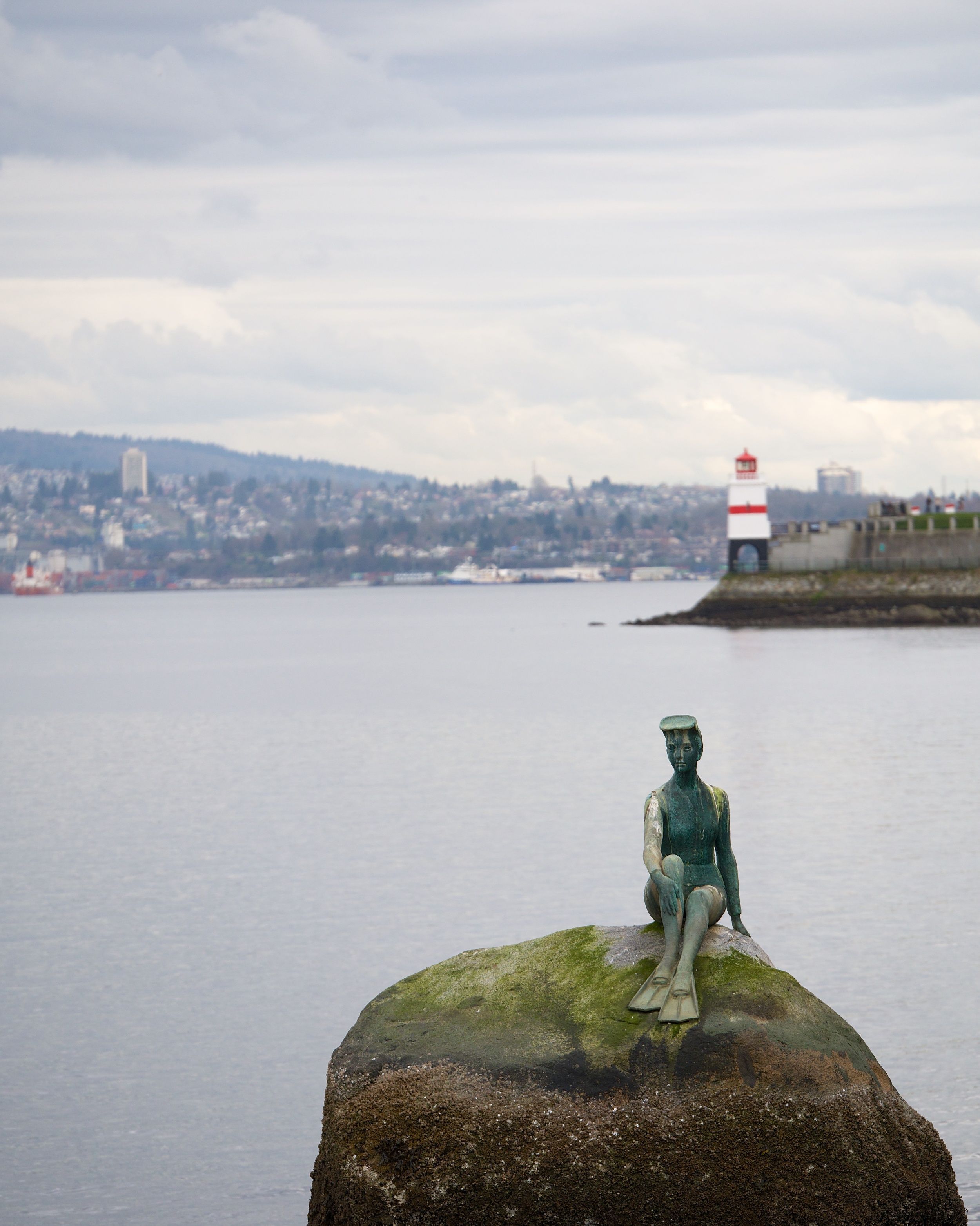 Girl in a Wet Suit and Brockton Point Lighthouse