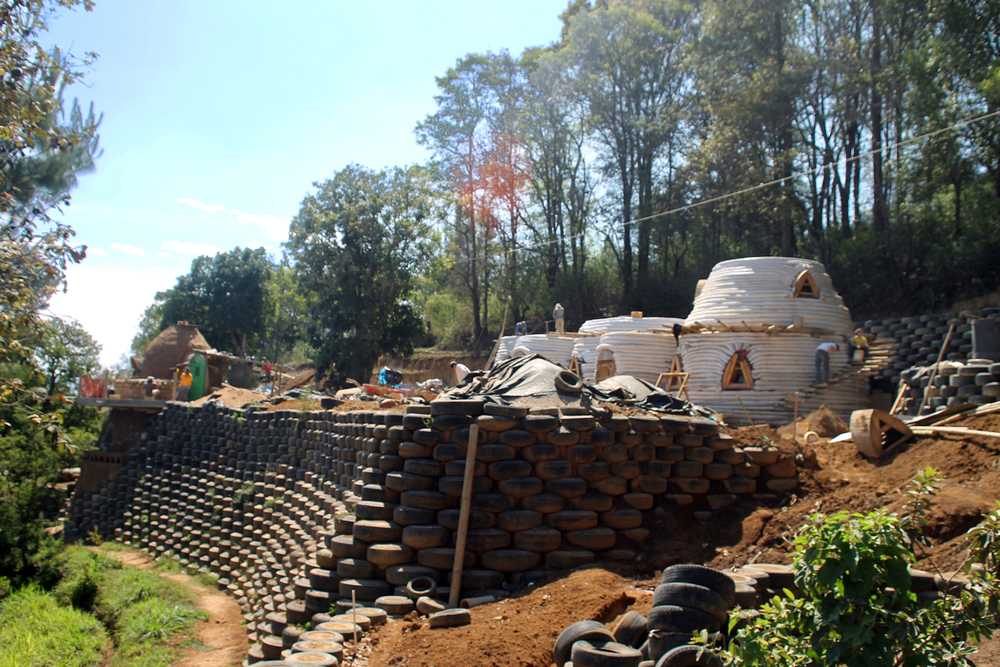 This image shows a retaining wall made from tyres - a recycled building material