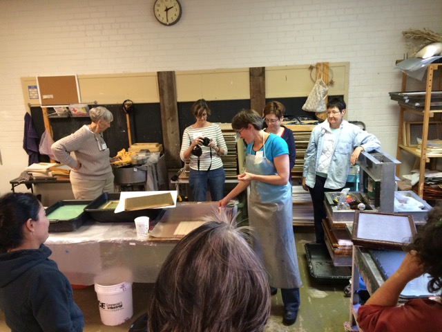 © 2016 Helen Hiebert, a group photo from last year’s retreat watching Helen give a papermaking demo.