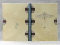 © 2013 Peter D Verheyen, Gaylord Schanilec and Clarke Garry, Mayflies of the Driftless Region , Midnight Paper Sales Press, 2005 Dorfner/de Gonet "open joint" binding; sewn on 3 brown salmon leather slips; flyleaves and doublures of Cave Paper “layered indigo day” paper; graphite top edge; rolled endbands brown salmon leather; spine covered in gray salmon leather; boards covered in full vellum with printed illustrations from text below; salmon leather slips attached to boards and framed with decorative weathered wood veneer; tied mayfly attached to front board. 26.5 x 19 x 2 cm