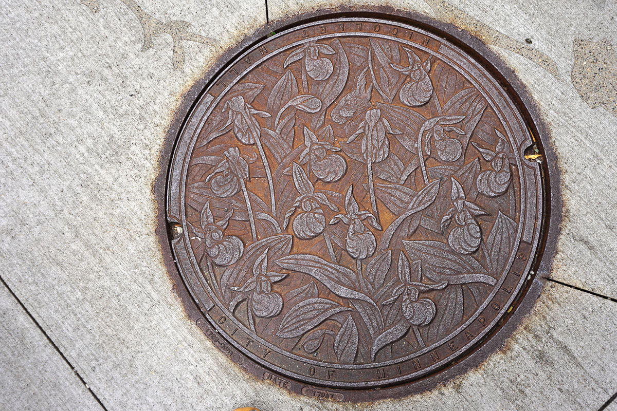 © 2018 Louise Levergneux. Lady Slippers, manhole cover on Nicollet Mall, designed by Kate Burke.